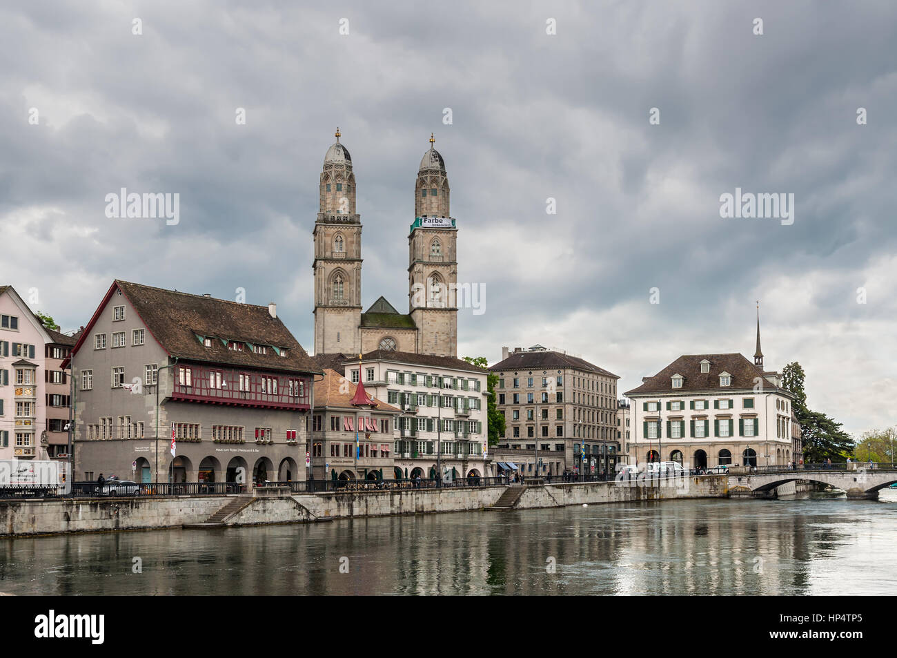 Zurich, Switzerland - May 24, 2016: View of the Grossmunster church (Great Minster), various houses and Limmat river in Zurich in overcast rainy weath Stock Photo