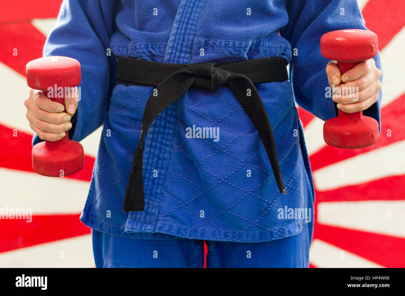 Close Up of Woman in Blue Judo Gi, and Black Belt, which is Train with