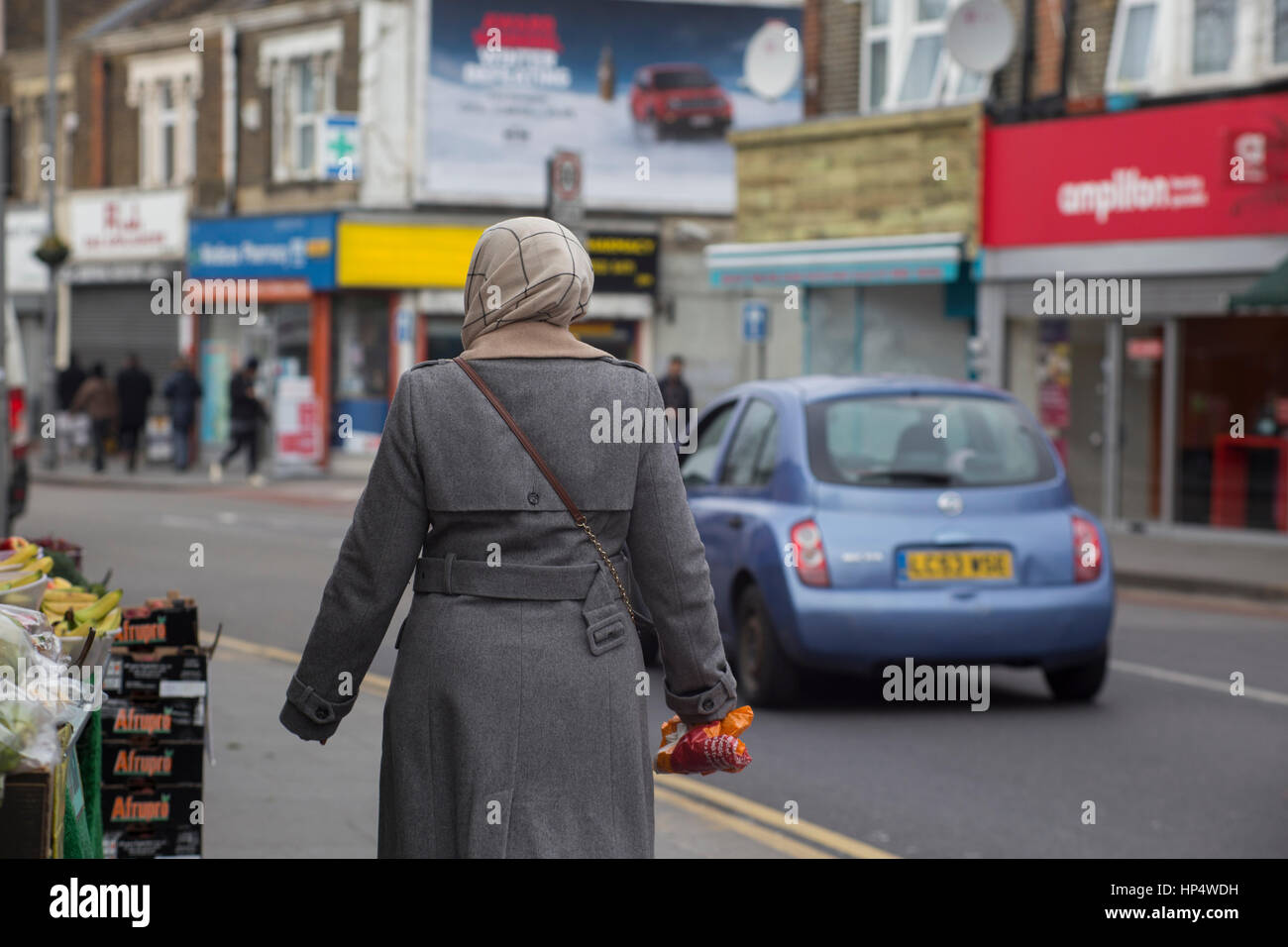 Woman walking up Hoe Street, near Baker's Arms, London. Stock Photo