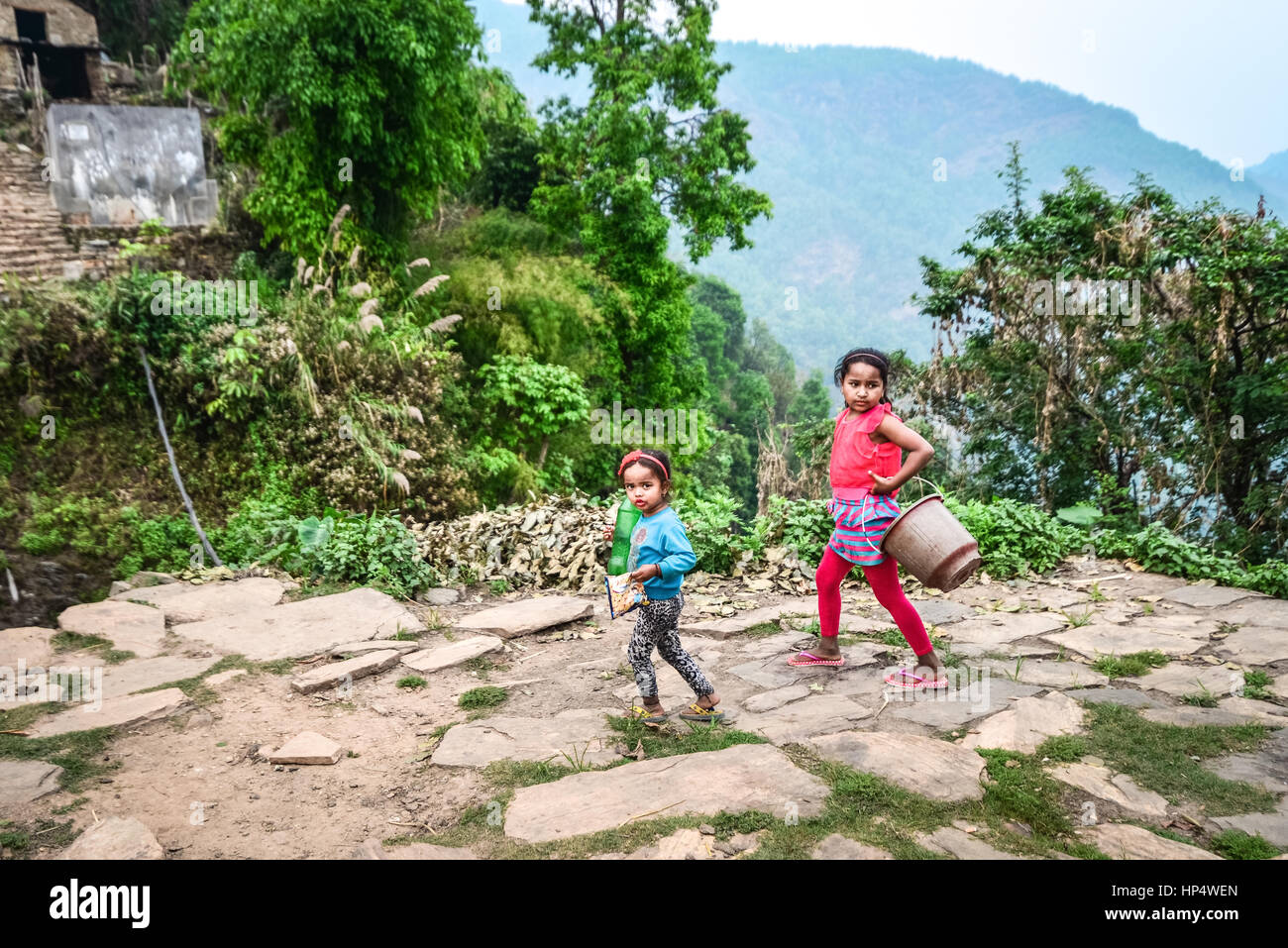 Children going to the fountain to take water in Damdame village, Kaski district, Gandaki, Nepal. Stock Photo