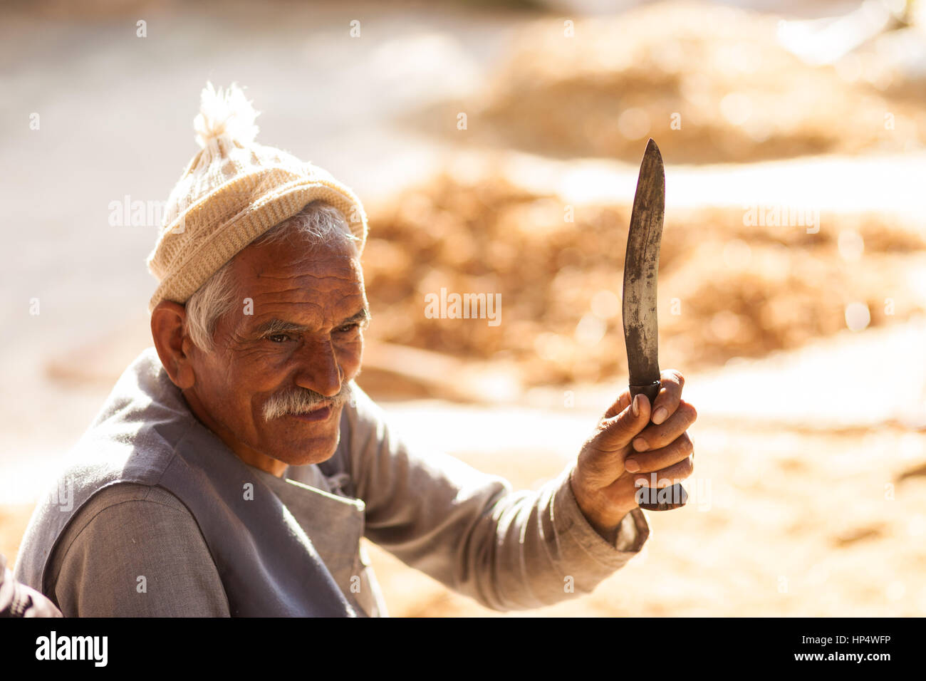 Nepali farmer holding a traditional Khukuri (Kukri) knife Stock Photo