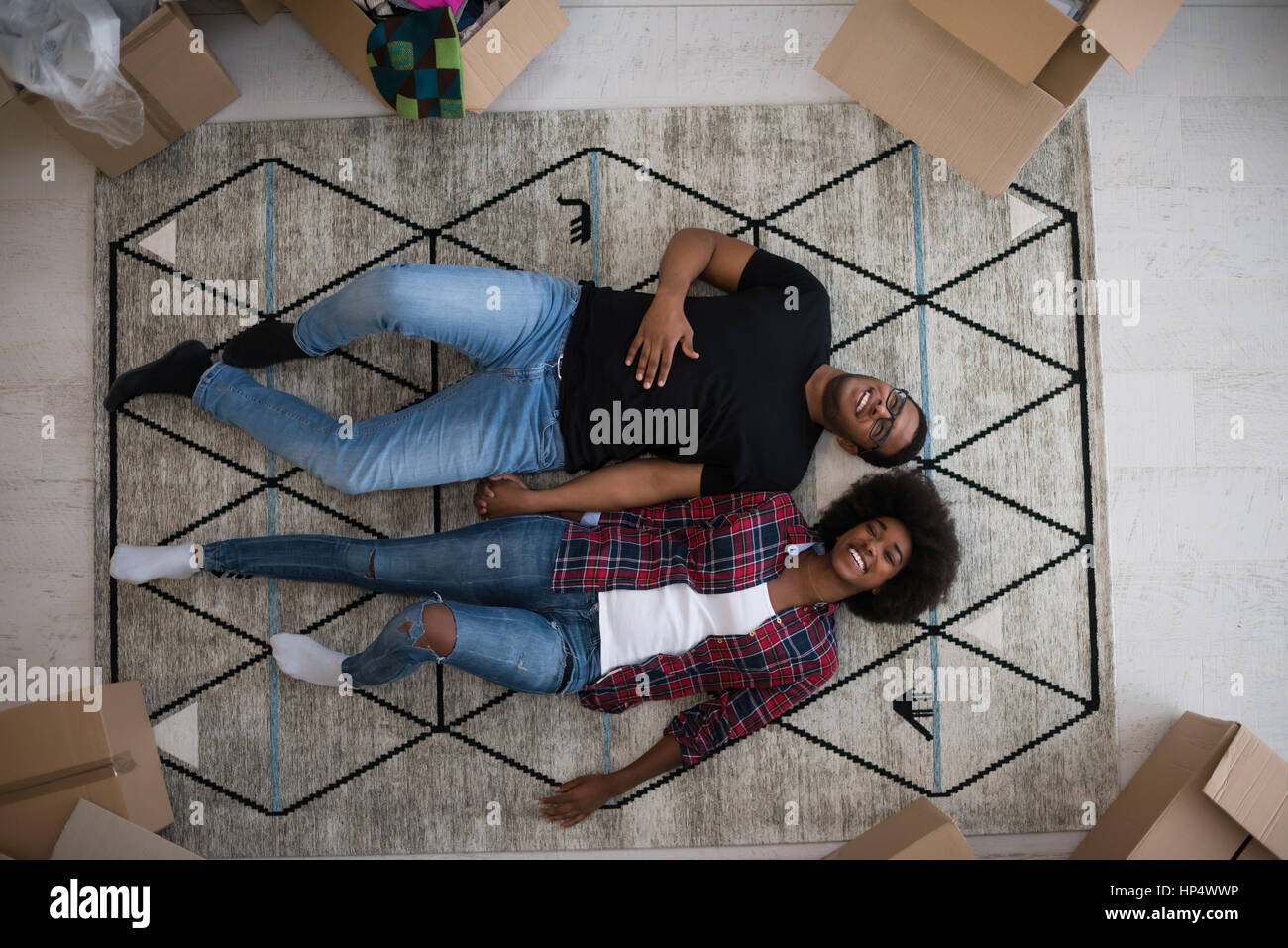 Top view of attractive young African American couple moving, holding ...