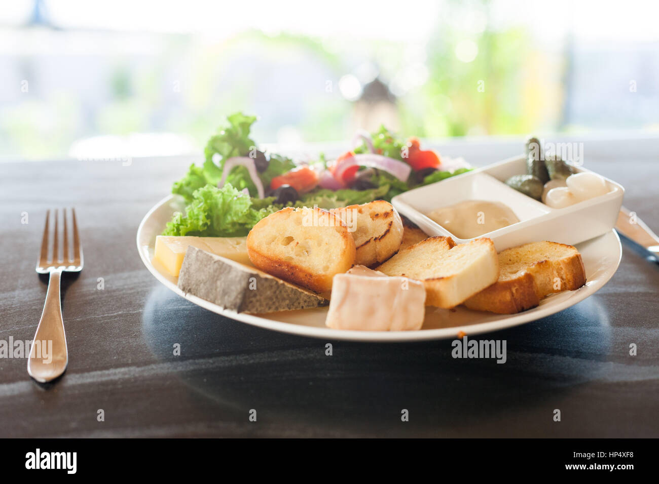 A French chesse plate with Tomme, Belkot, and Saint Marcellin cheeses