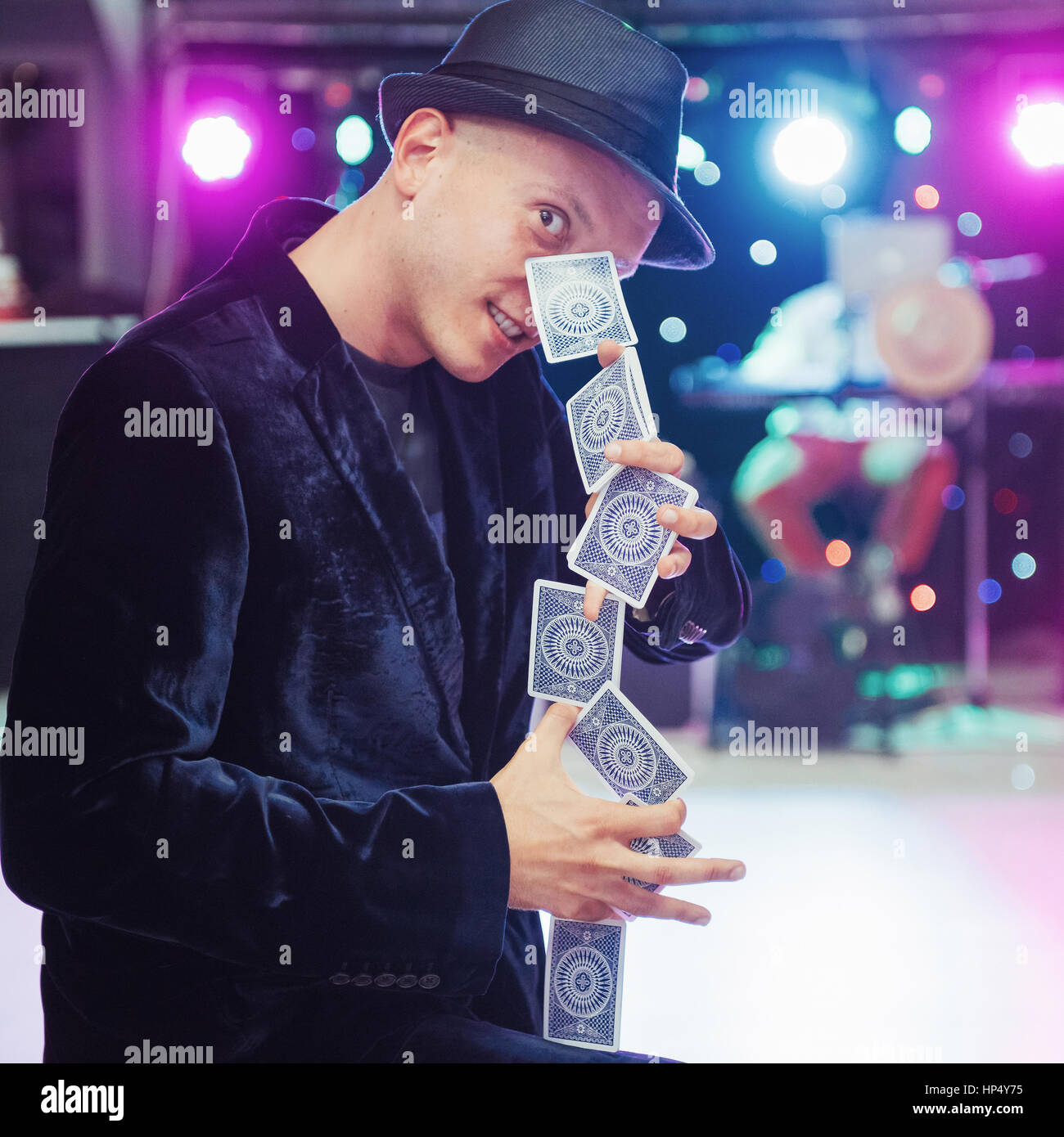 Portrait juggler magician is interesting black suit with cards i Stock