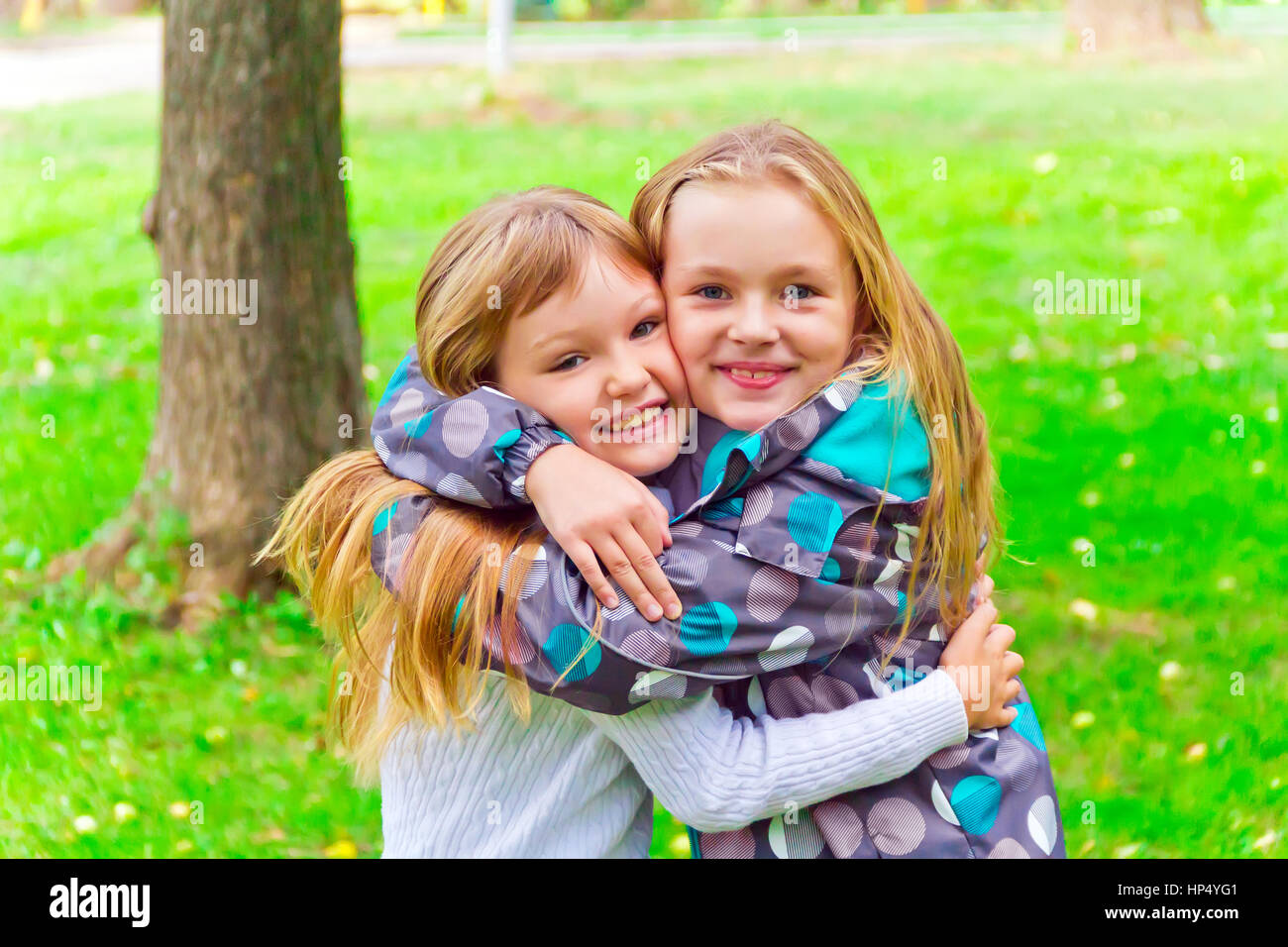 Photo of two embracing girls in summer Stock Photo - Alamy