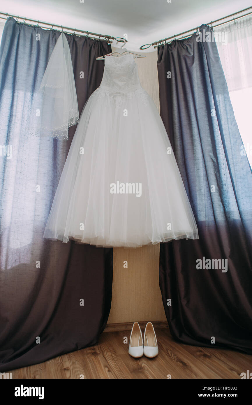 wedding dress hanging up by the door Stock Photo - Alamy