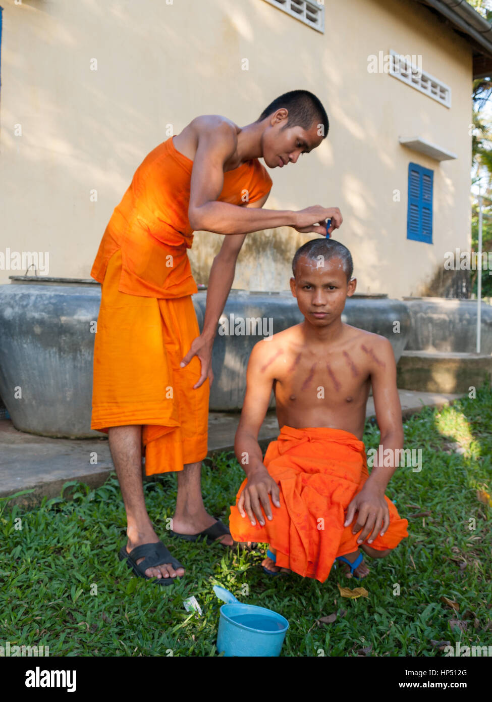 Cambodian monk portrait while shaving head Stock Photo