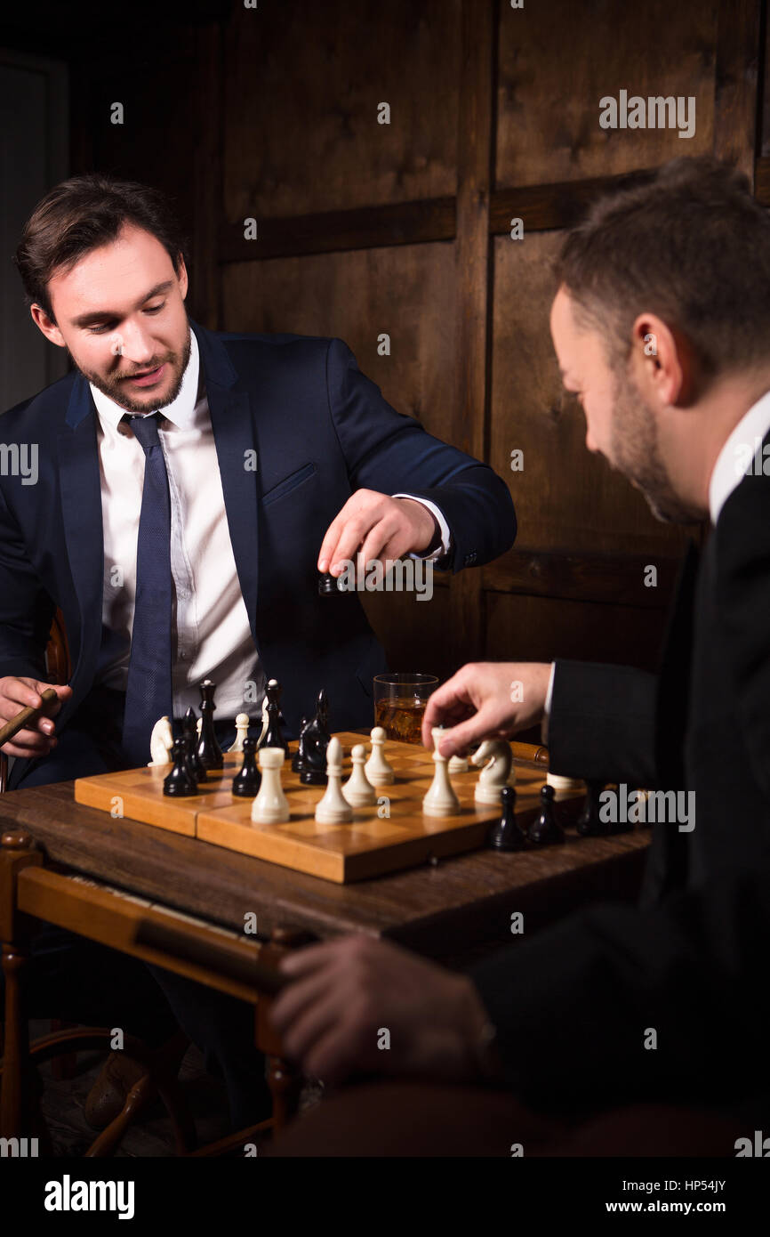 Rich businessmen playing chess Stock Photo