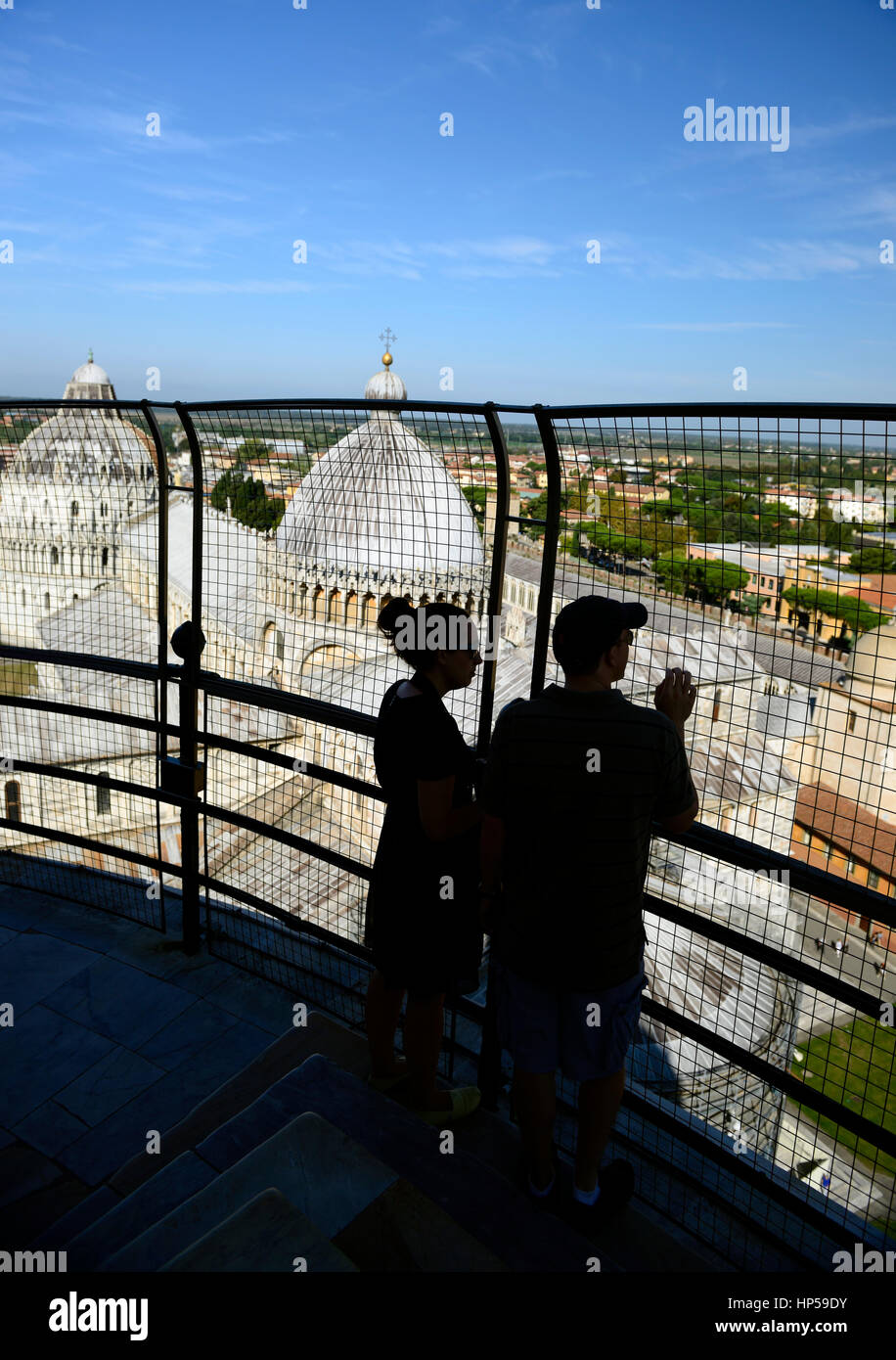 leaning Tower of Pisa, tourists, silhouette, silhouetted, couple, tourism, view, viewing, viewpoint, from, The Baptistery, Duomo, Leaning Tower, Piazz Stock Photo