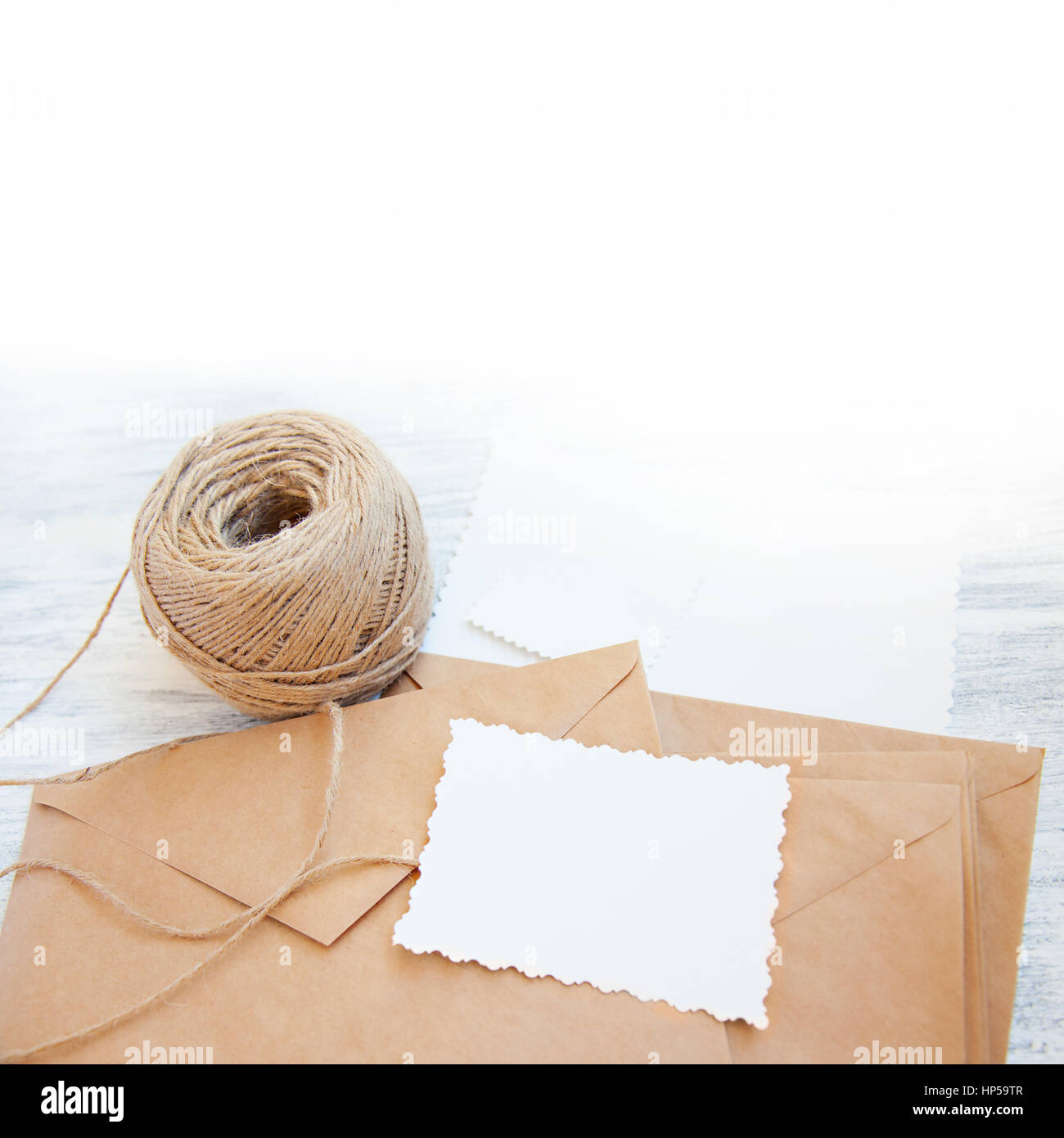 Vintage stillife with brown rough paper envelopes, skein of cord and ...