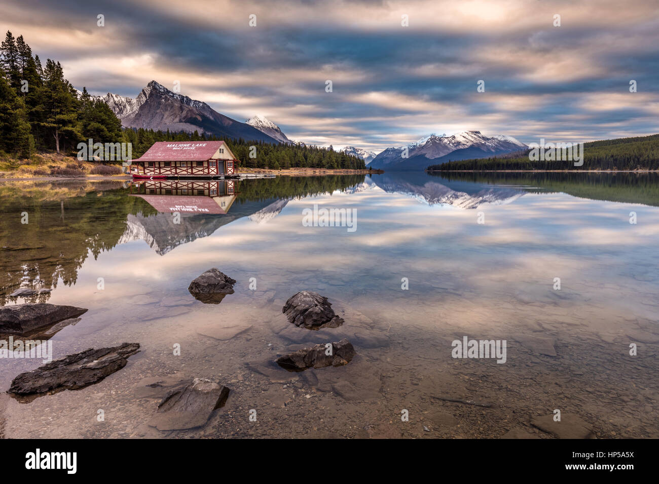Maligne Lake Boat House reflection at sunrise in the wilderness of Jasper National Park, in the heart of the Canadian Rockies. Stock Photo