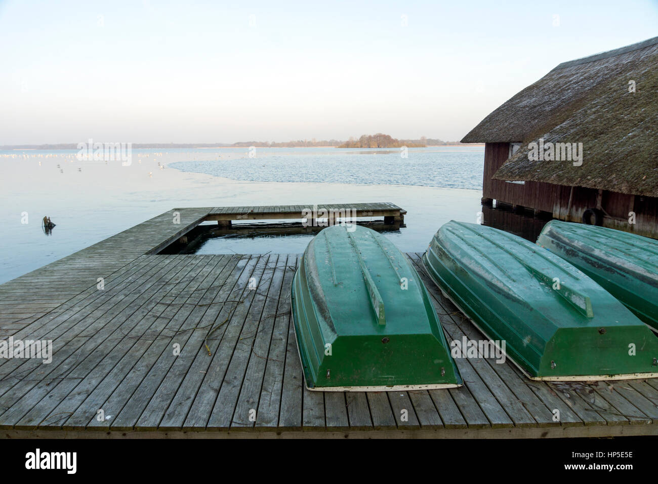 Boat dock at the lake with boat house Stock Photo