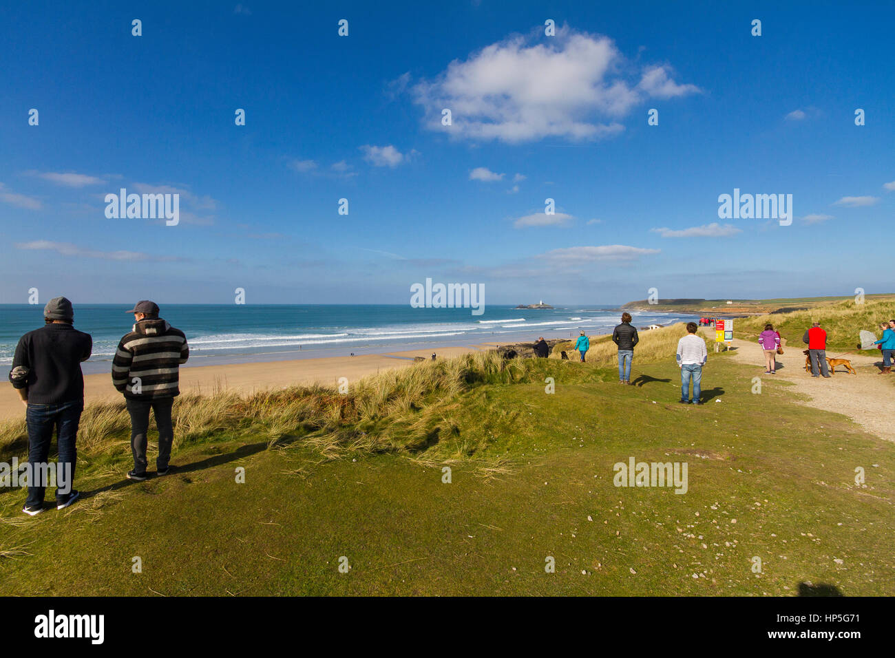 A family picnics on a cliff top in the sun after a surf in the briny. Stock Photo