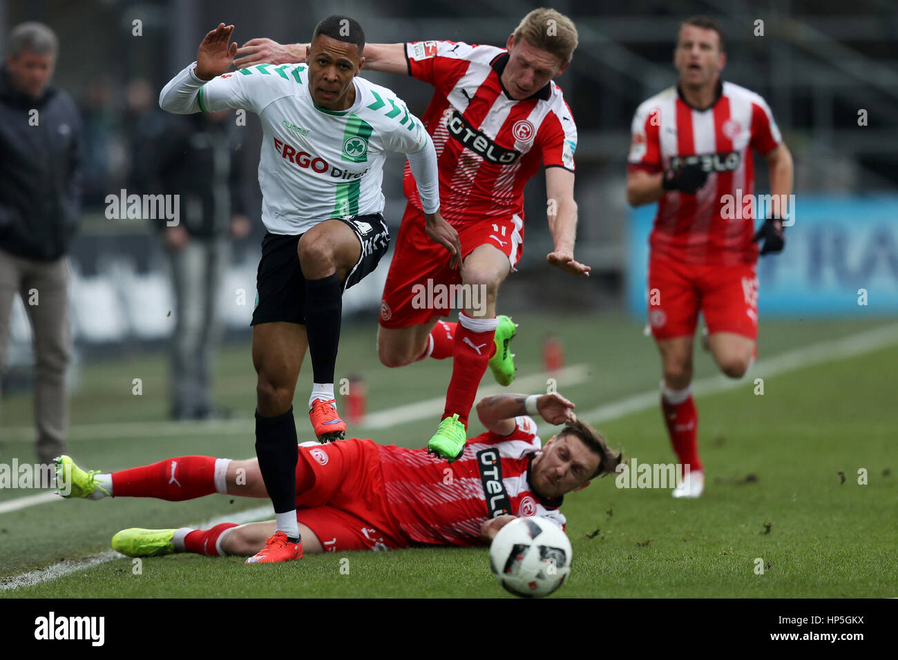 Fuerth, Germany. 18th Feb, 2017. Fuerth's Mathis Bolly (L) in action against Duesseldorf's Adam Bodzek (bottom) and Axel Bellinghausen (C) during the German second division Bundesliga soccer match between SpVgg Greuther Fürth and Fortuna Duesseldorf at Sportpark Ronhof Thomas Sommer in Fuerth, Germany, 18 February 2017. (EMBARGO CONDITIONS - ATTENTION: Due to the accreditation guidelines, the DFL only permits the publication and utilisation of up to 15 pictures per match on the internet and in online media during the match.) Photo: Daniel Karmann/dpa/Alamy Live News Stock Photo