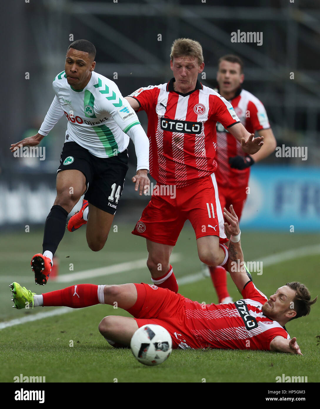 Fuerth, Germany. 18th Feb, 2017. Fuerth's Mathis Bolly (L) in action against Duesseldorf's Adam Bodzek (bottom) and Axel Bellinghausen (C) during the German second division Bundesliga soccer match between SpVgg Greuther Fürth and Fortuna Duesseldorf at Sportpark Ronhof Thomas Sommer in Fuerth, Germany, 18 February 2017. (EMBARGO CONDITIONS - ATTENTION: Due to the accreditation guidelines, the DFL only permits the publication and utilisation of up to 15 pictures per match on the internet and in online media during the match.) Photo: Daniel Karmann/dpa/Alamy Live News Stock Photo