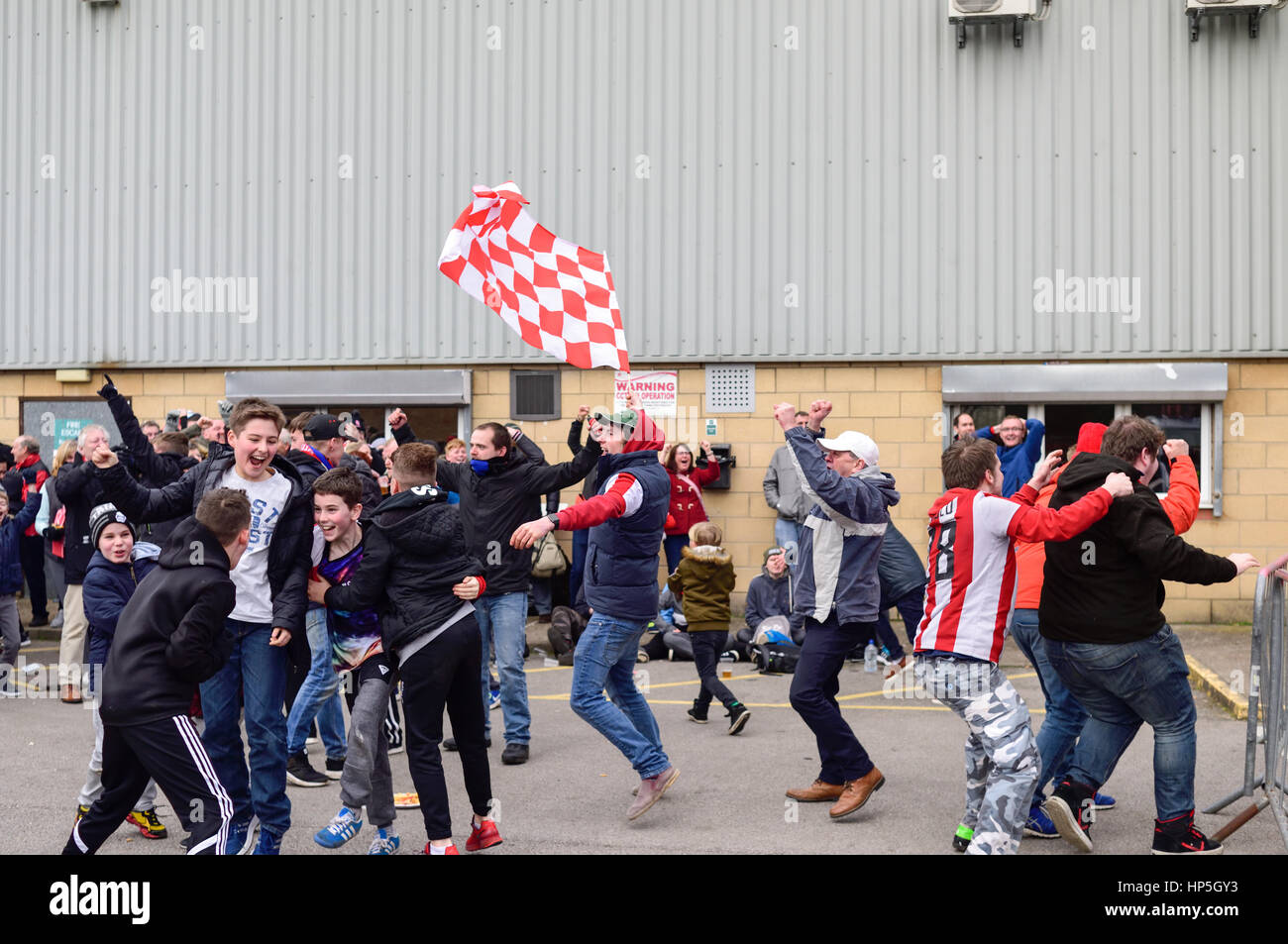 Lincoln, UK. 18th Feb, 2017. Non-league Lincoln city FC supporters celebrate shock win over Premier League club Burnley and a place in the FA Cup quarter-finals. Fans celebrate outside Sincil bank stadium home of the Imps, after watching the game via large screen TV. Credit: Ian Francis/Alamy Live News Stock Photo