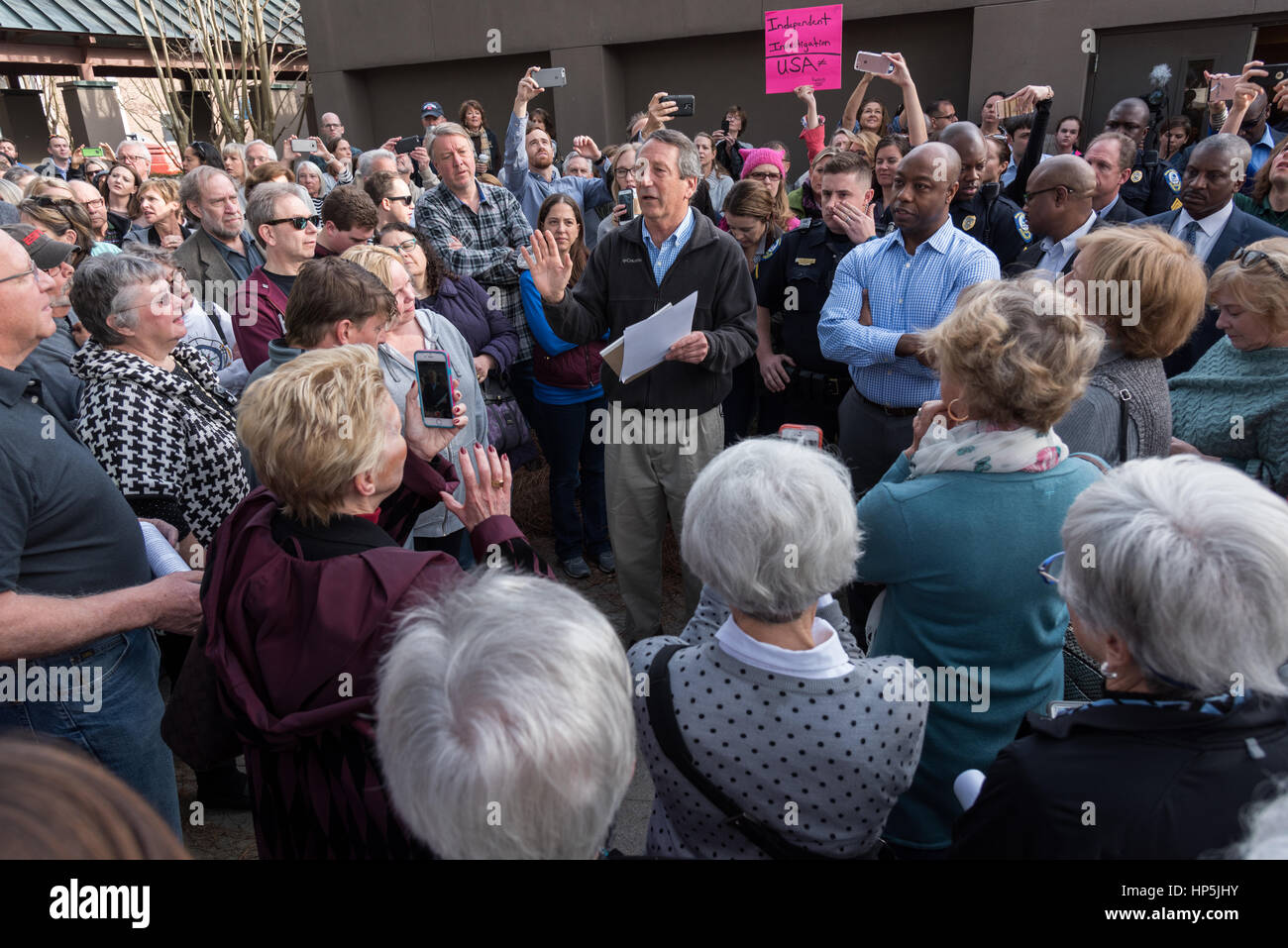 Mount Pleasant, South Carolina, USA. 18th February, 2017. U.S. Rep. Mark Sanford, center, and U.S. Sen. Tim Scott, right, meet with constituents who could not fit into a town hall meeting to discuss holding a second meeting February 18, 2017 in Mount Pleasant, South Carolina. Hundreds of concerned residents turned up for the meeting to address their opposition to President Donald Trump during a vocal meeting. Credit: Planetpix/Alamy Live News Stock Photo