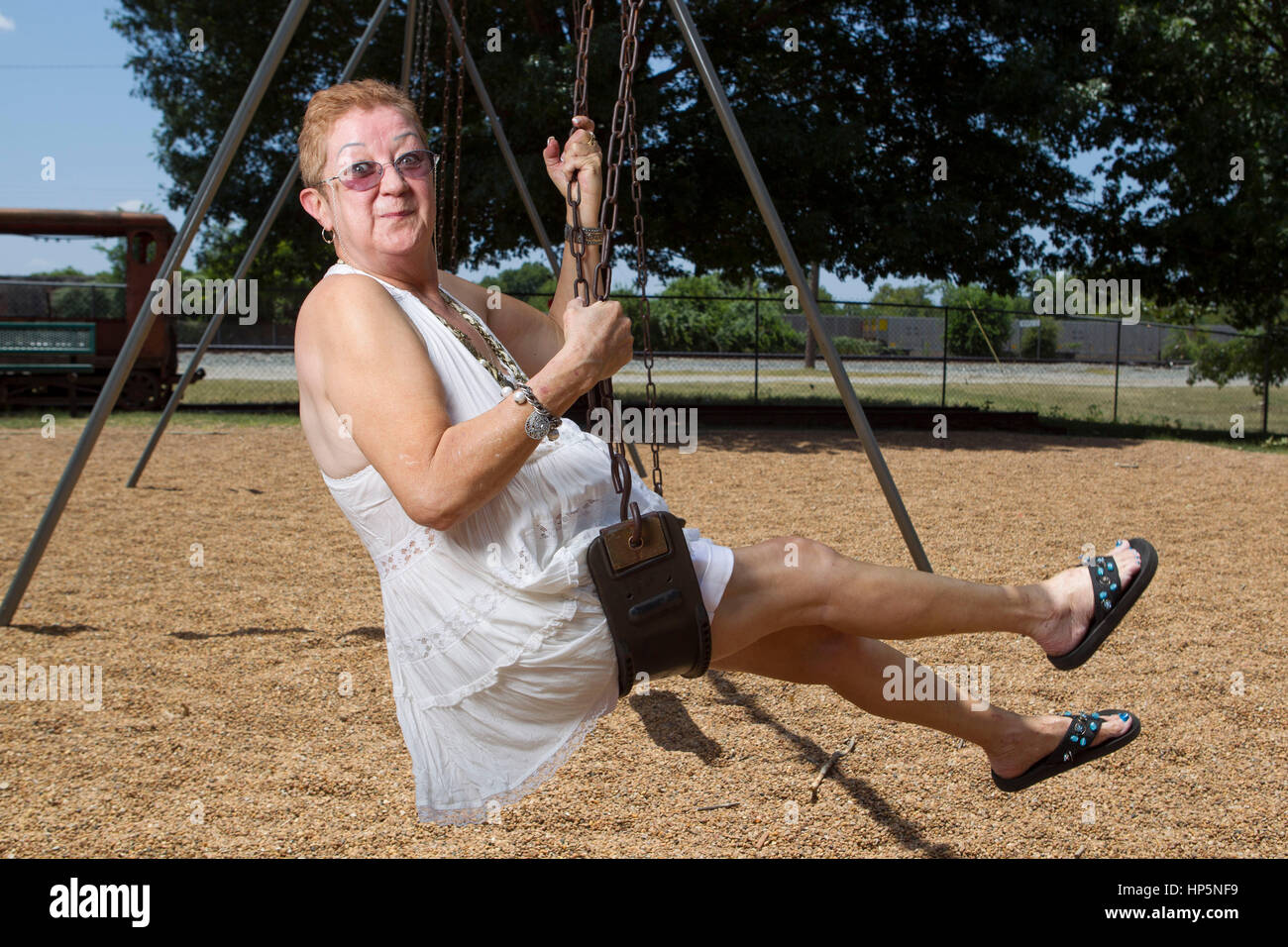 FILE Pic: Smithville, Texas, USA. July 15, 2011. Norma McCorvey, the anonymous plaintiff known as Jane Roe in the Supreme Court's landmark 1973 Roe vs. Wade ruling legalizing abortion in the United States, swings in a local park.  McCorvey died, Feb. 18, 2017 in an assisted living center in Katy, Texas Credit: Bob Daemmrich/Alamy Live News Stock Photo