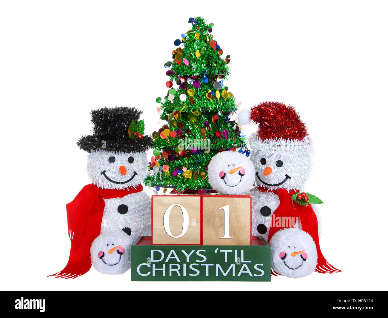 01 Days until Christmas light beech wood blocks with red trim on a green base with tinsel christmas tree, mr and mrs snowman and snowball snowmen head Stock Photo