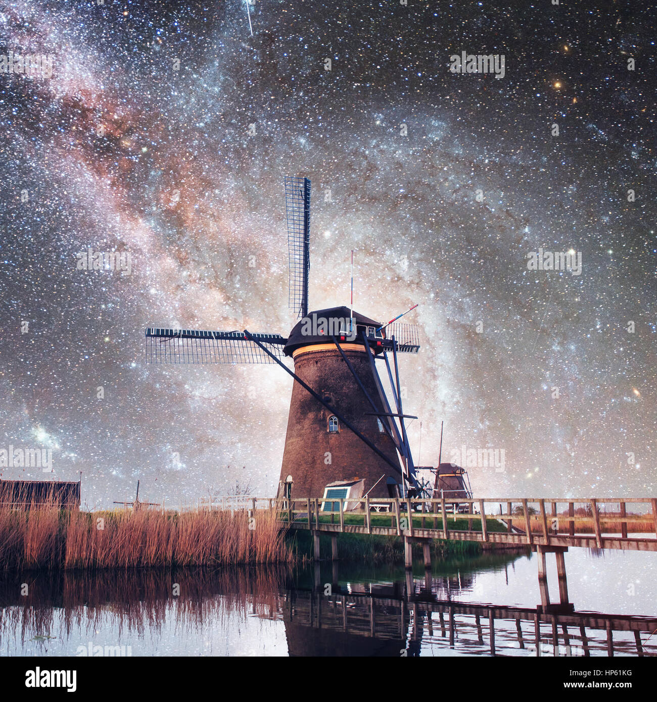 Dutch mill at night. Starry sky. Courtesy of NASA. Holland Stock Photo