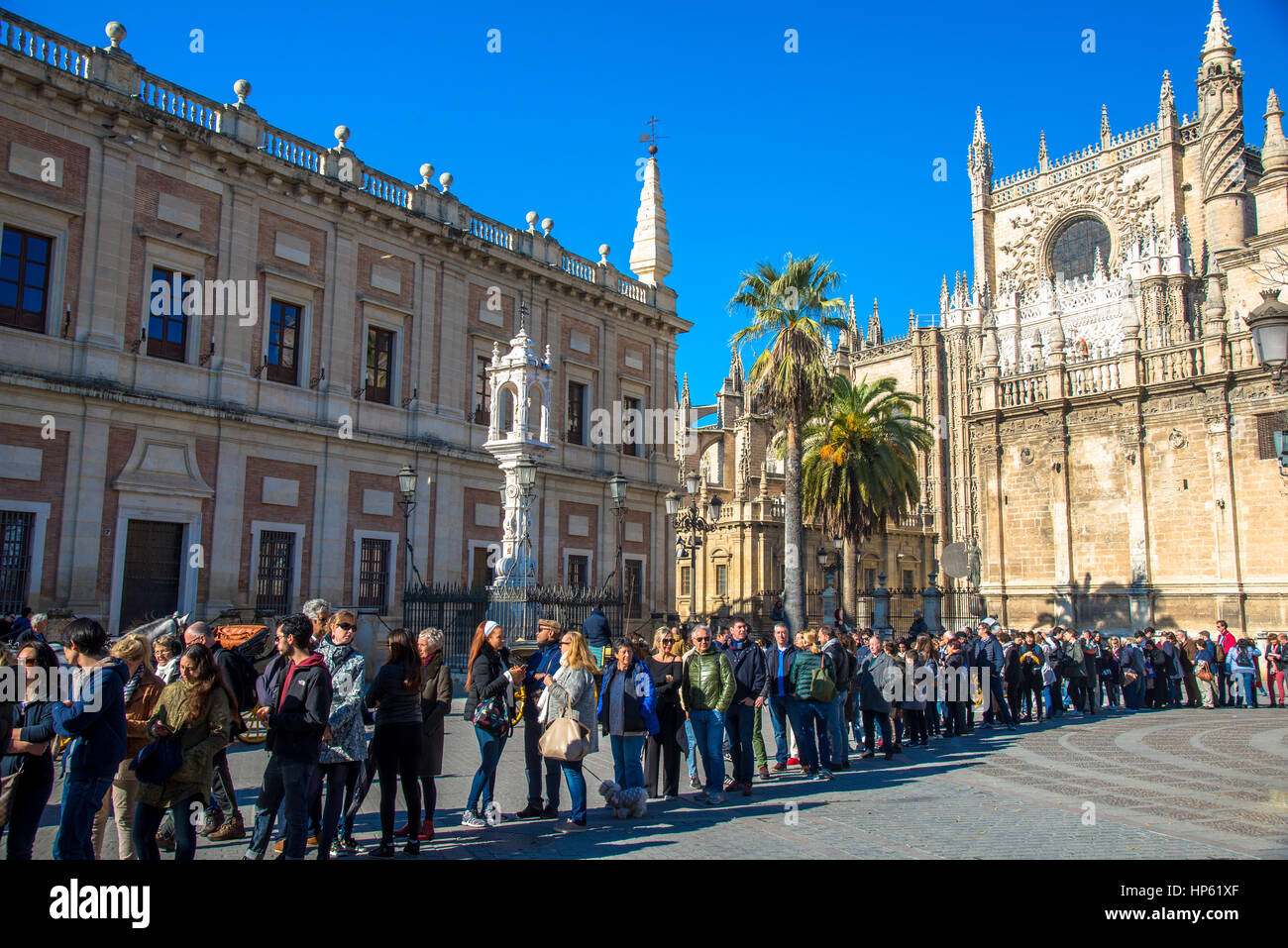 tourists waiting in line for entrance of Real Alcazar, palace in Sevilla, Spain Stock Photo