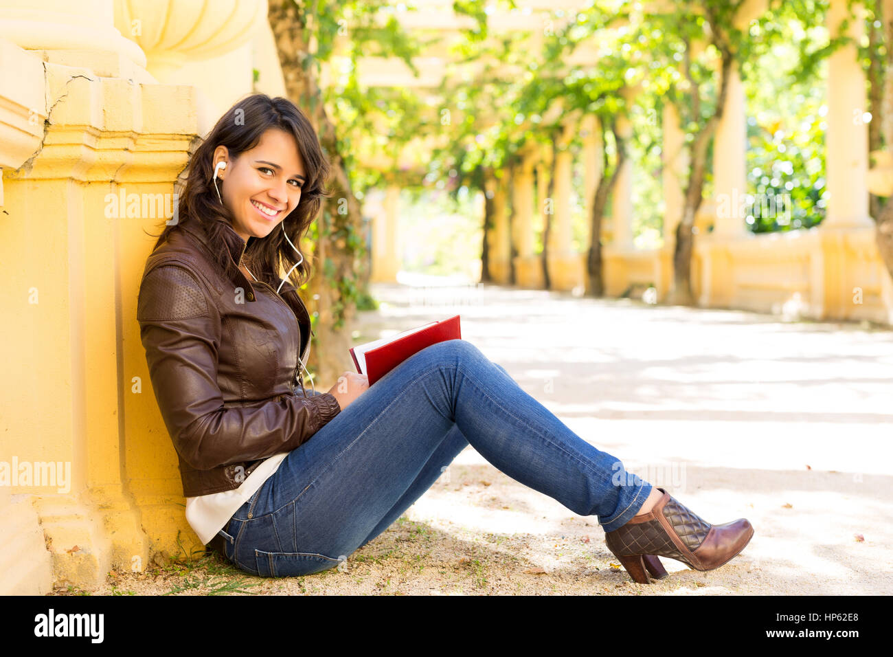 Young woman reading a book and relaxing at the park Stock Photo - Alamy