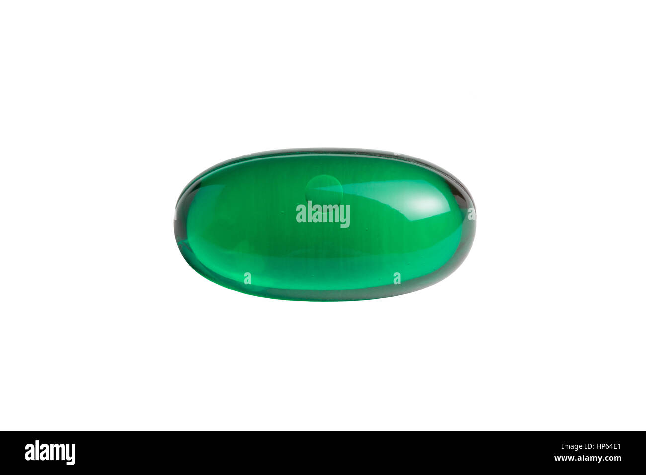 Green gelatin capsule or pill isolated on a white background. Medically