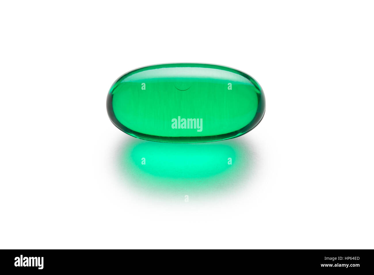 Green gelatin capsule or pill isolated on a white background.  Medically themed studio macro with backlighting for extra pop. Stock Photo