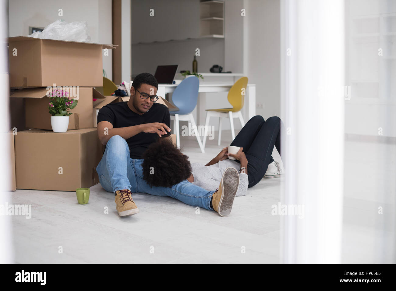 Relaxing in new house. Cheerful young African American couple sitting ...
