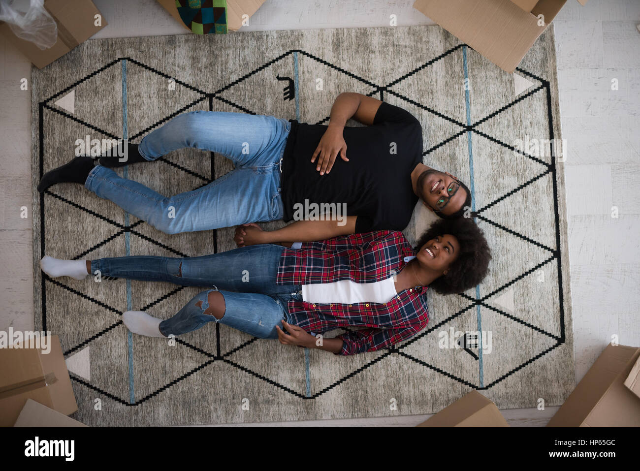 Top view of attractive young African American couple moving, holding ...