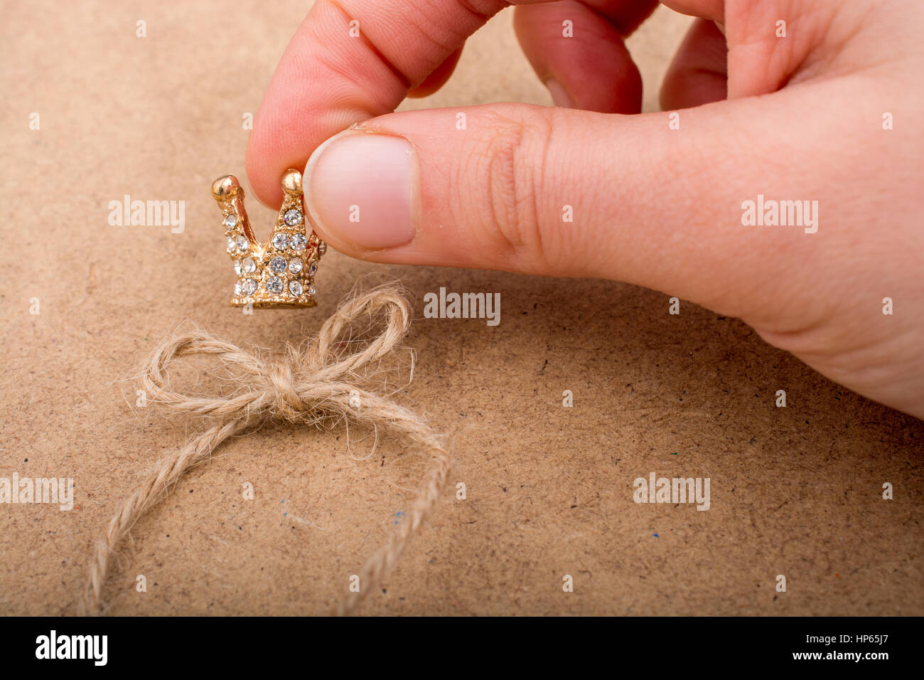 Golden color crown model with pearls on brown background Stock Photo ...