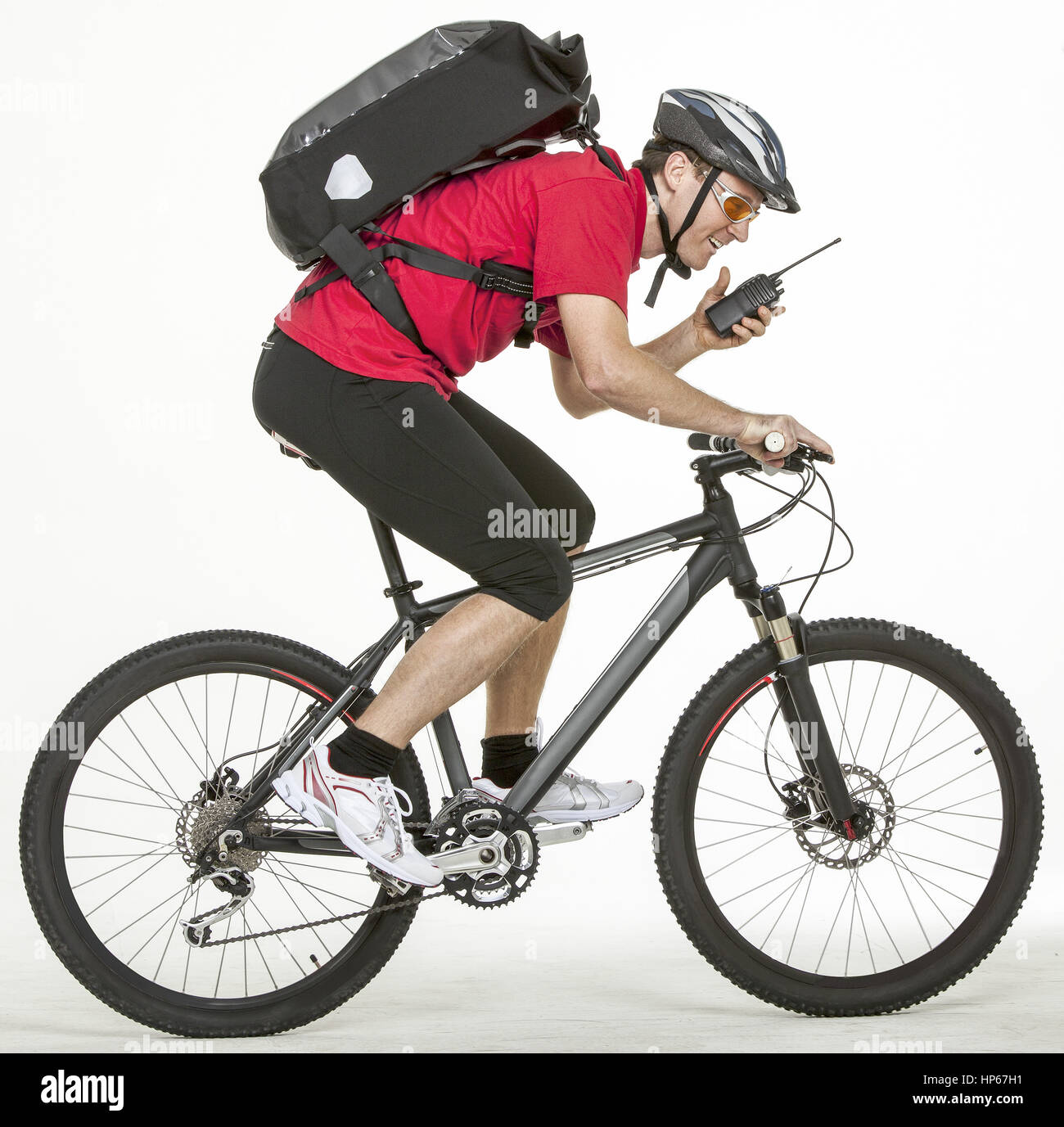 Fahrradkurier auf Rad mit Funkgeraet (model-released) Stock Photo