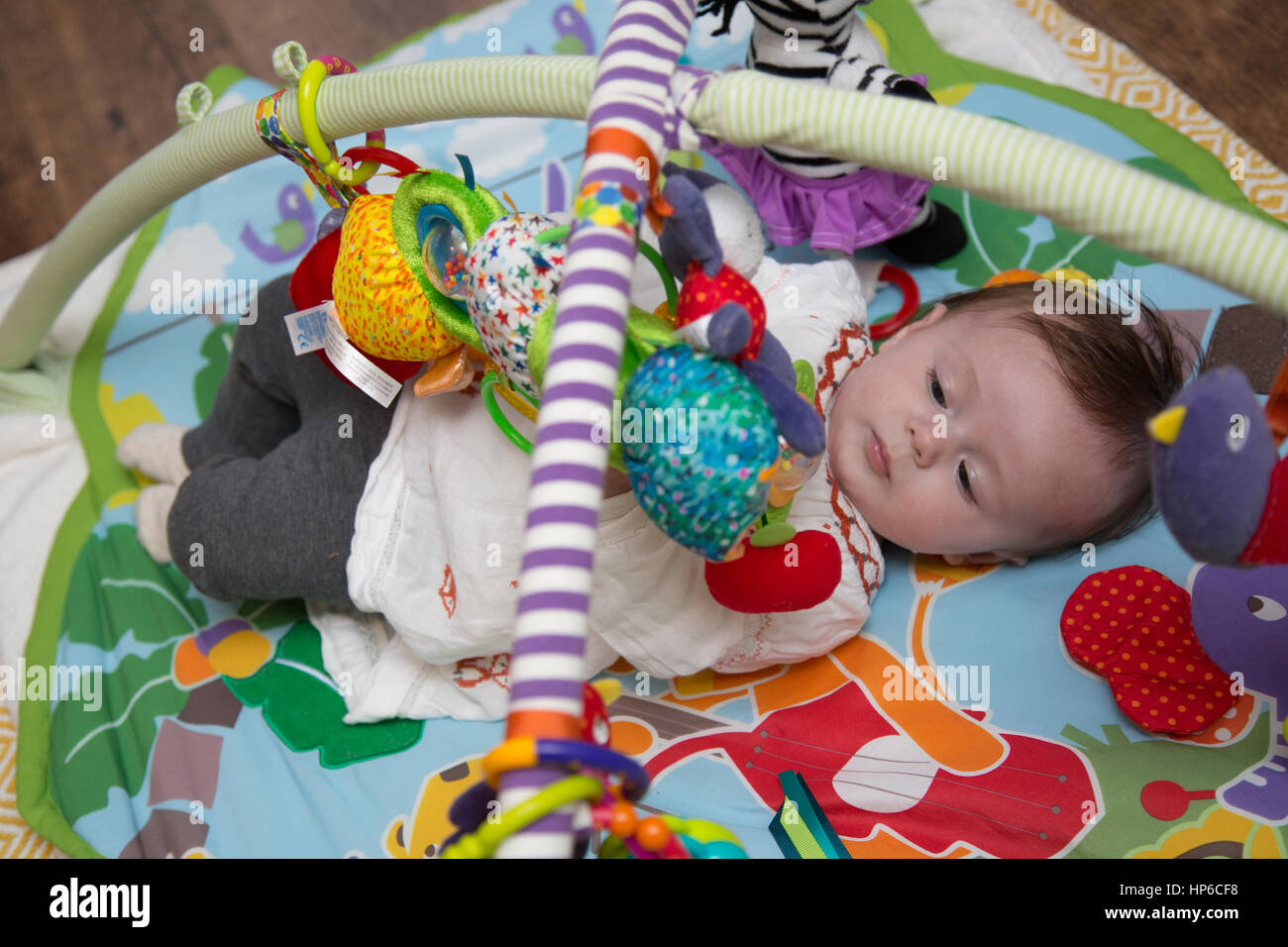 Baby playing on play mat Stock Photo