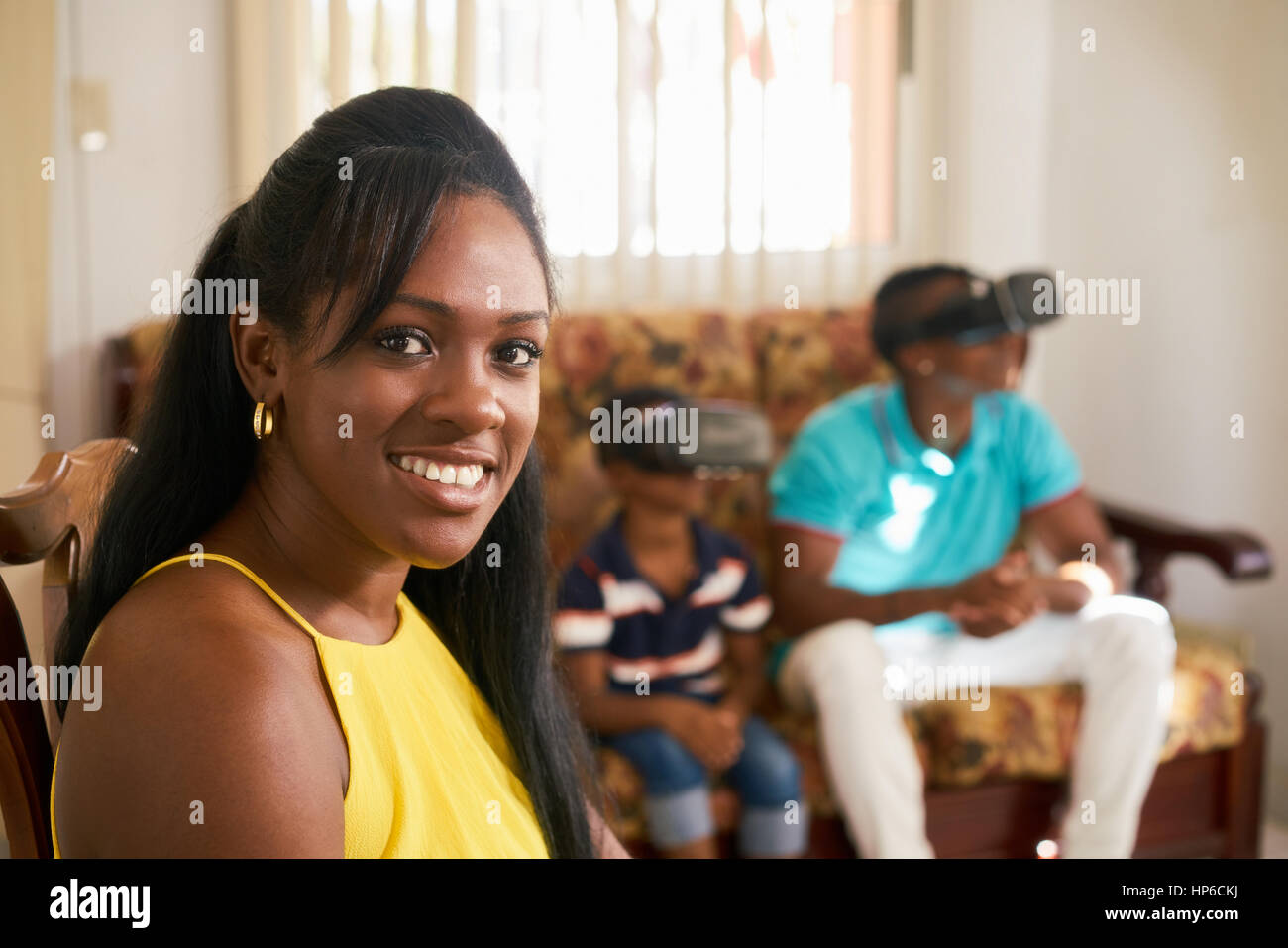 Happy black family at home. African american father, mother and child. Dad, mom and son playing virtual reality. Portrait of woman smiling at camera Stock Photo