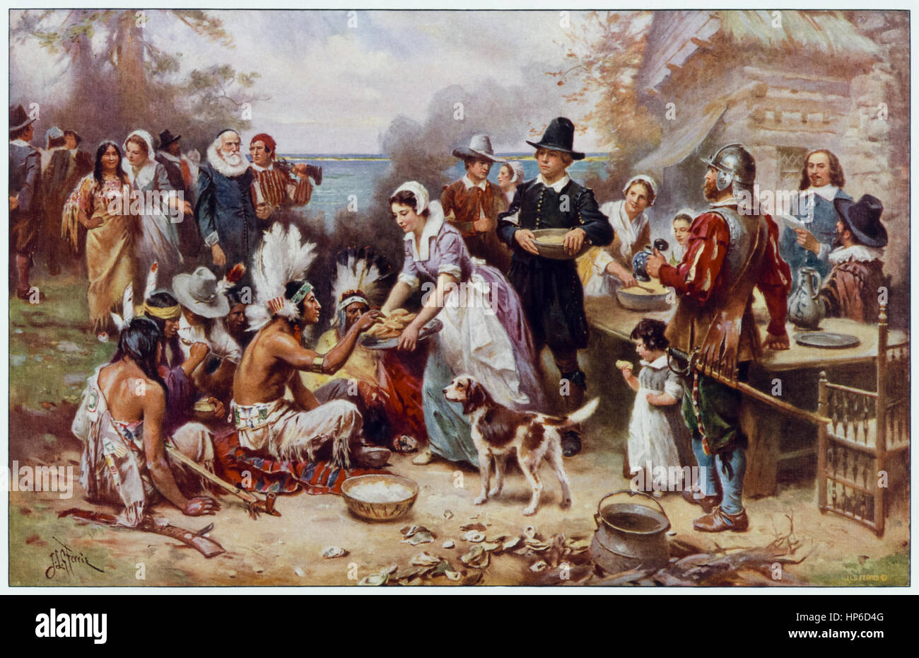 “The First Thanksgiving 1621” by Jean Leon Gerome Ferris (1863-1930) American artist who painted many scenes from American history; in this idealized scene Native Americans and Pilgrims share a meal. Stock Photo