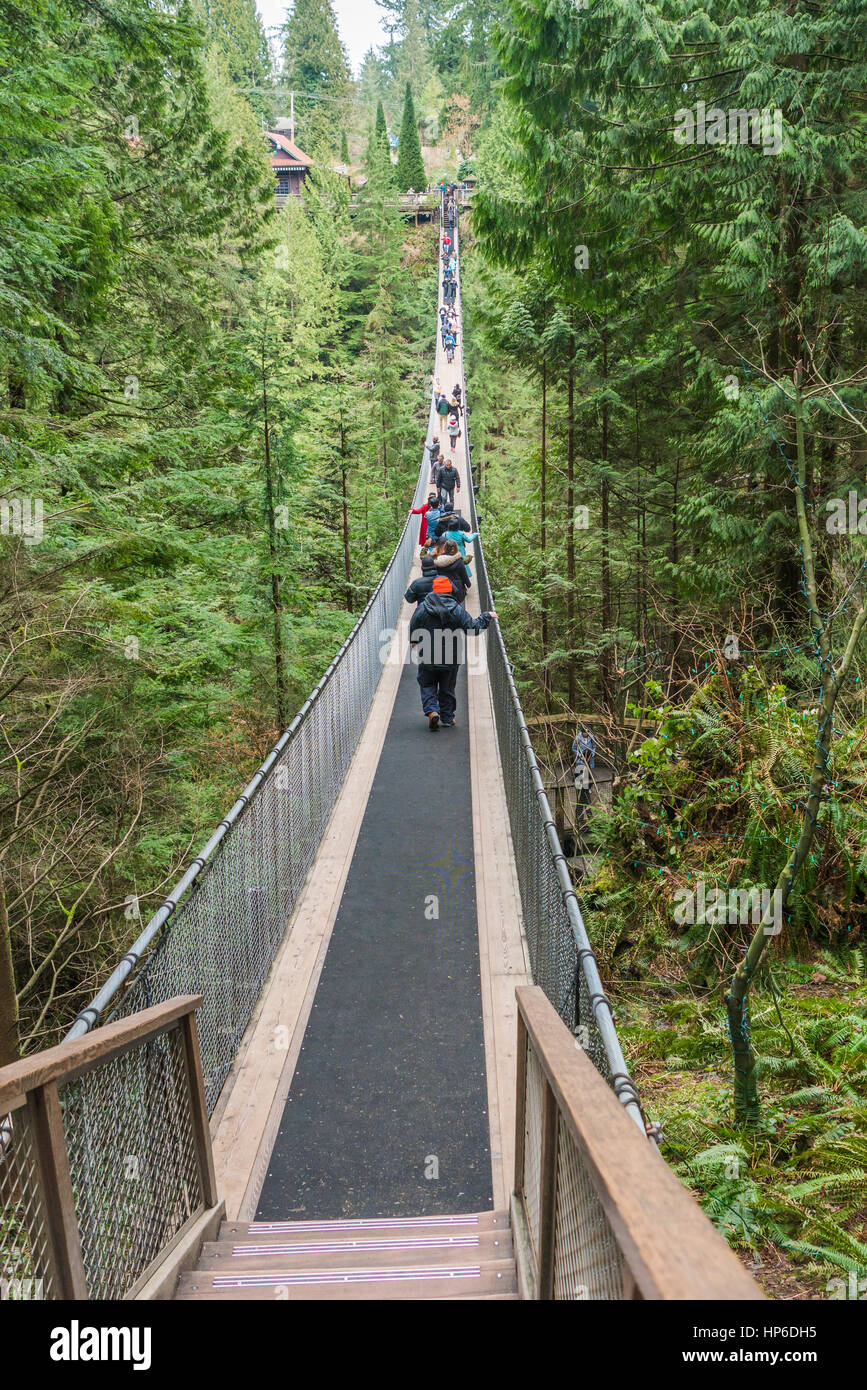 Vancouver, Canada - January 28, 2017: Many sightseers make their way across the Capilano Suspension Bridge. Stock Photo