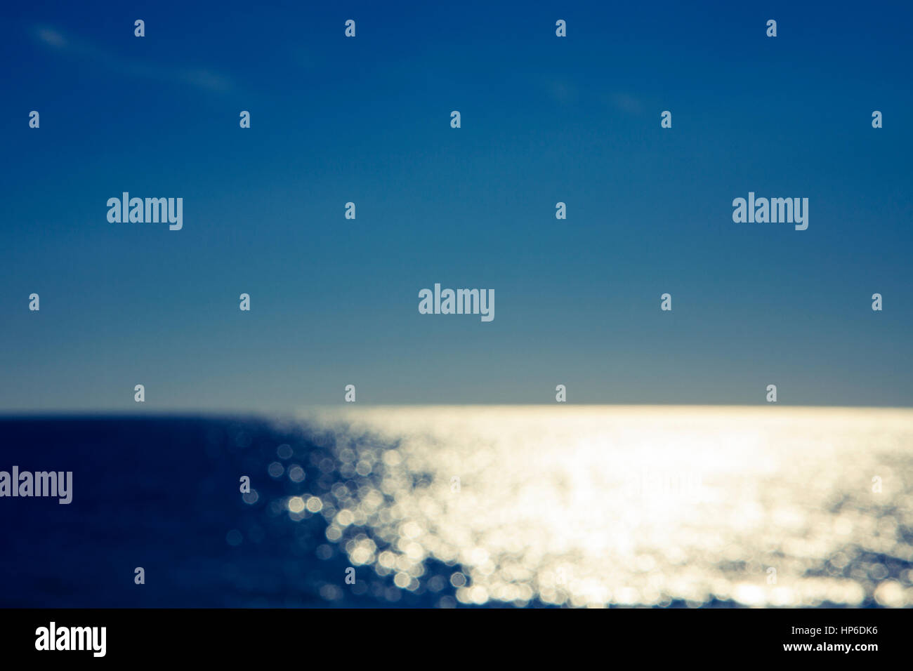 Blurred abstract ocean background. Sunlight reflecting on water. Bokeh effect. Stock Photo