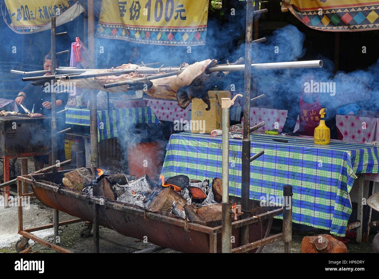 KAOHSIUNG, TAIWAN -- JULY 24, 2016: A traditional market in the aboriginal mountain village of Baoshan offers roast pig, sausages, rice cooked in bamb Stock Photo