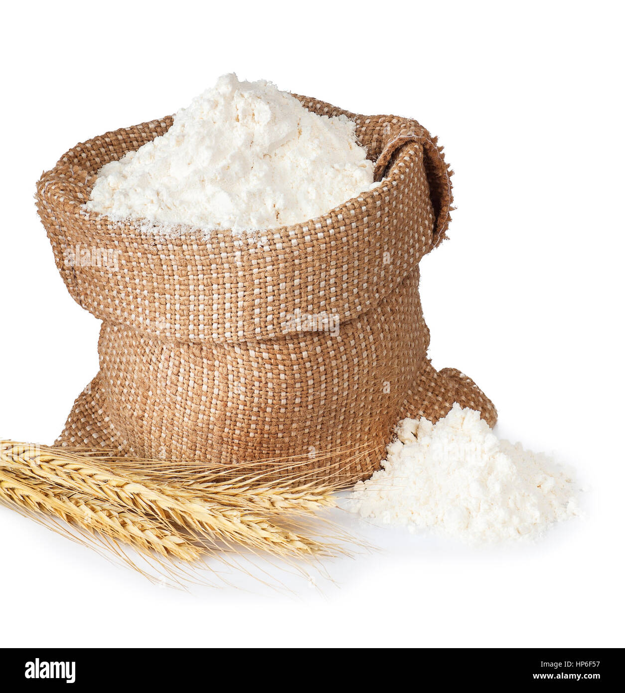 flour in bag with wheat ears isolated on white background. Full sack of flour Stock Photo
