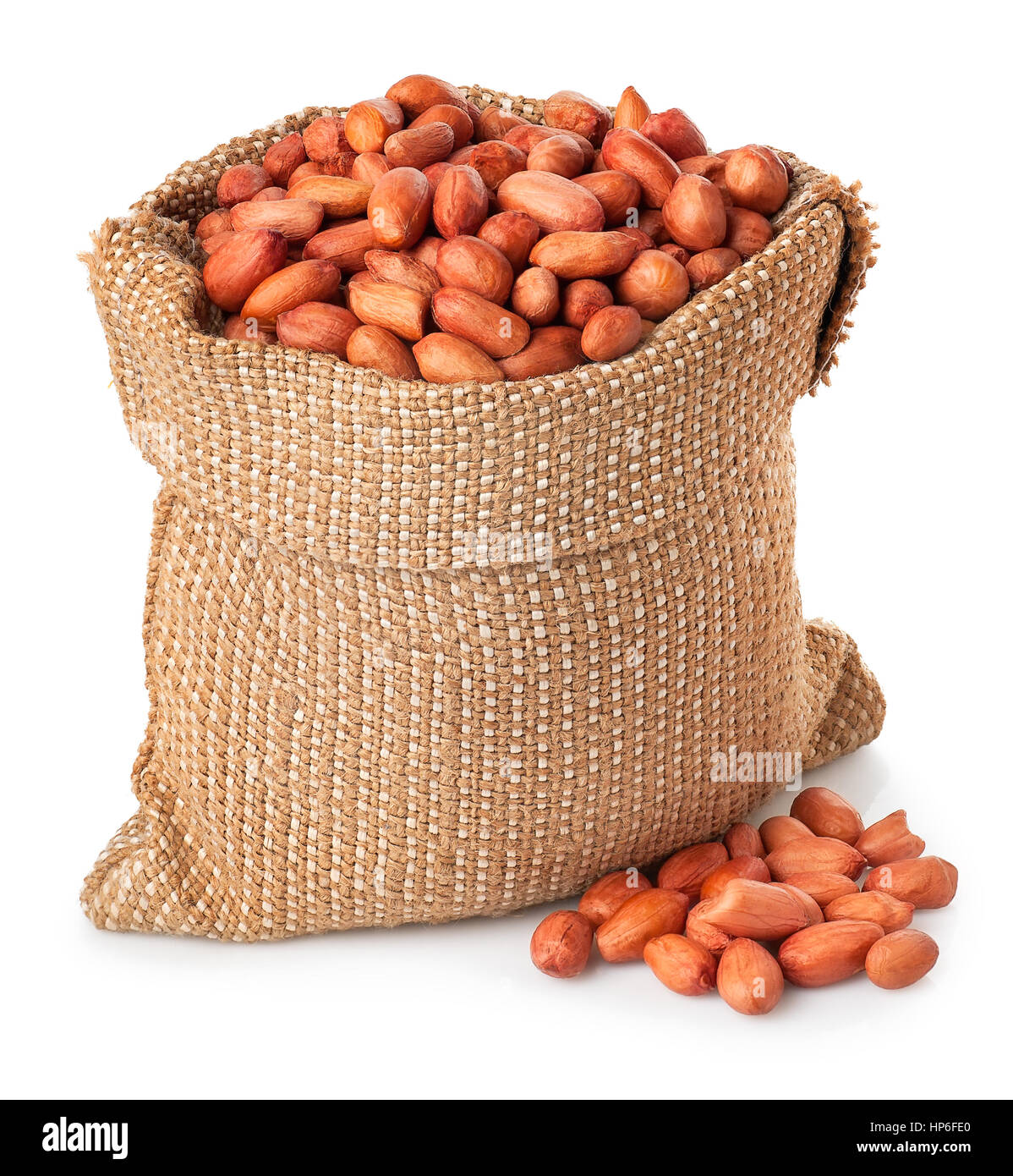 Peanut or groundnut in burlap bag with heap isolated on white