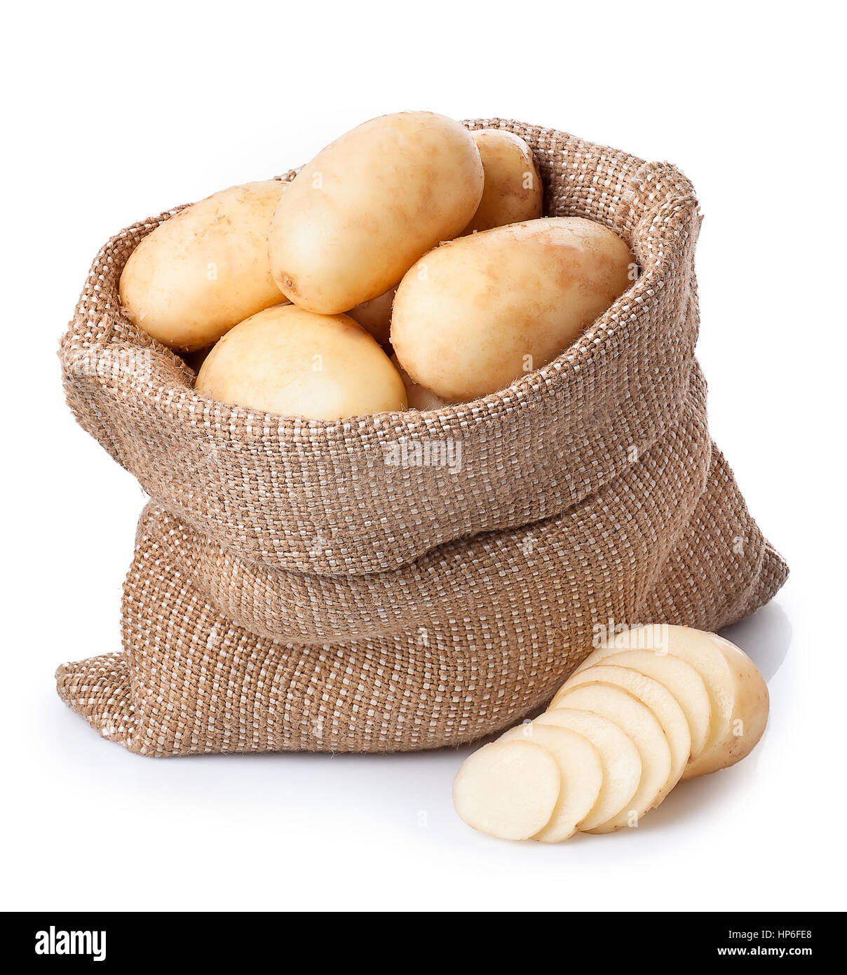 new fresh raw potatoes in bag  with sliced potato beside isolated on white background. Ripe potatoes in burlap sack isolated on white background Stock Photo