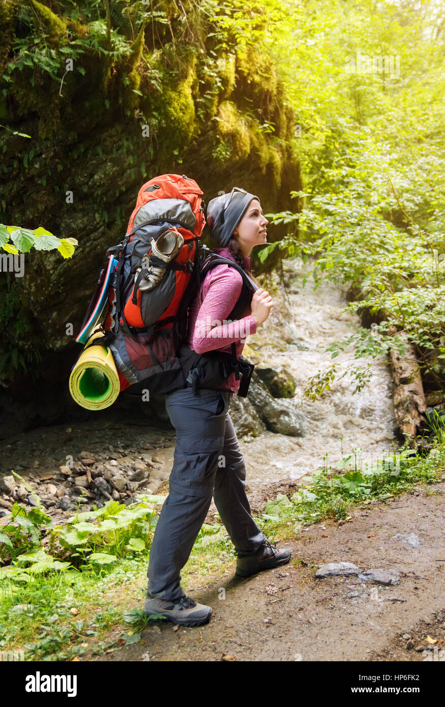 https://c8.alamy.com/comp/HP6FK2/woman-hiker-trekking-on-trail-in-mountains-river-and-rock-with-moss-HP6FK2.jpg
