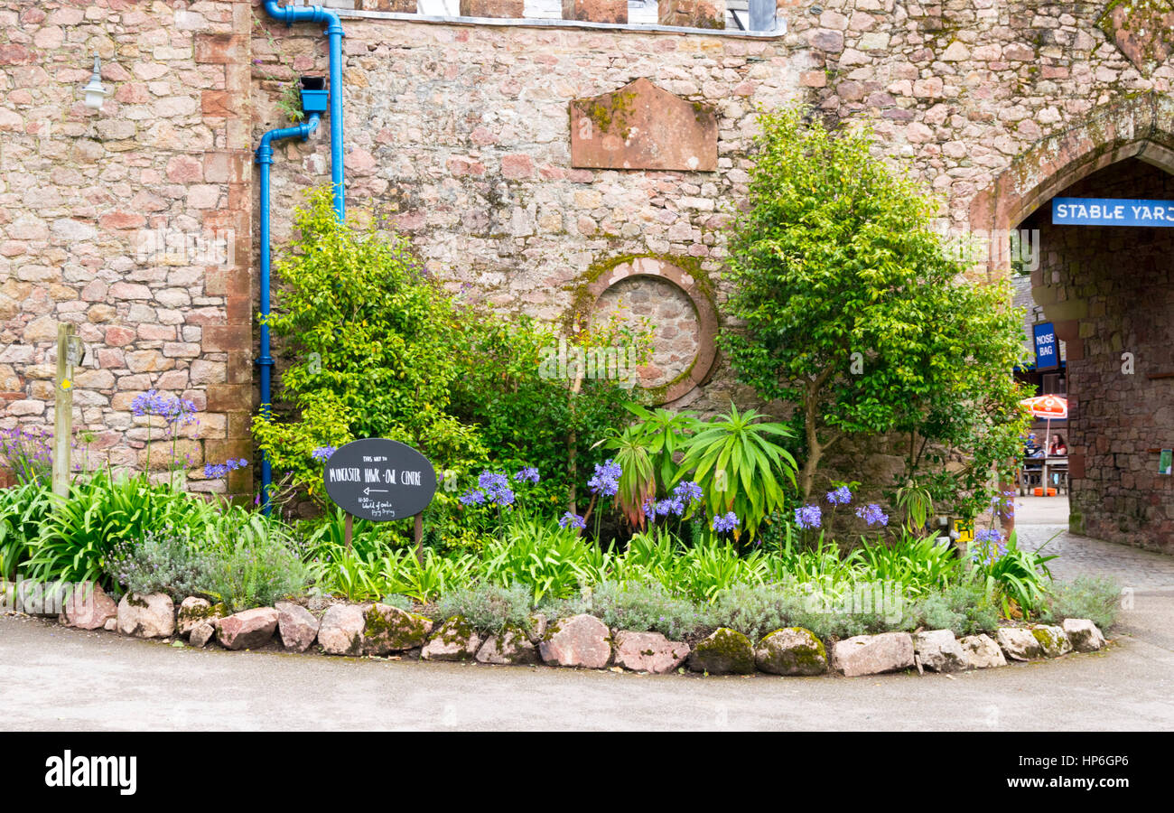 Entrance to stable yard cafe with sign for hawk and owl center at Muncaster Castle, Ravenglass, Cumbria, UK Stock Photo