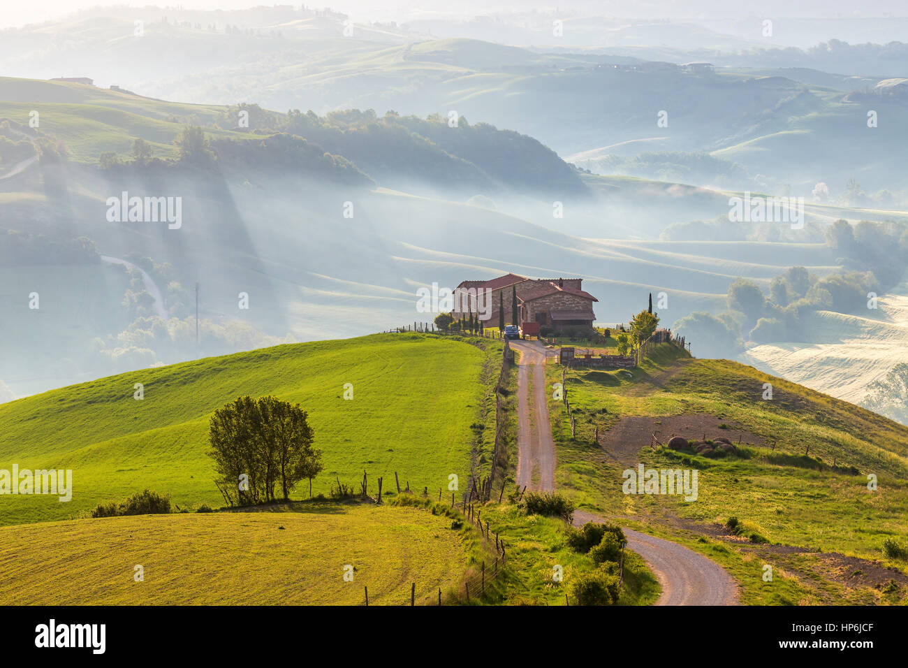 House on a hill in Tuscany with mist in the valley Stock Photo - Alamy