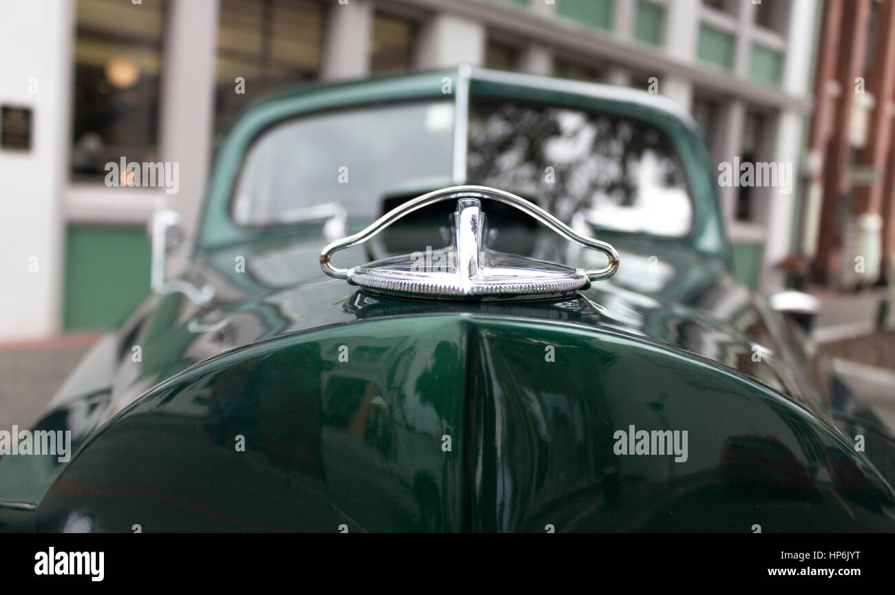 Close up of the hood ornament of a vintage green car. Stock Photo