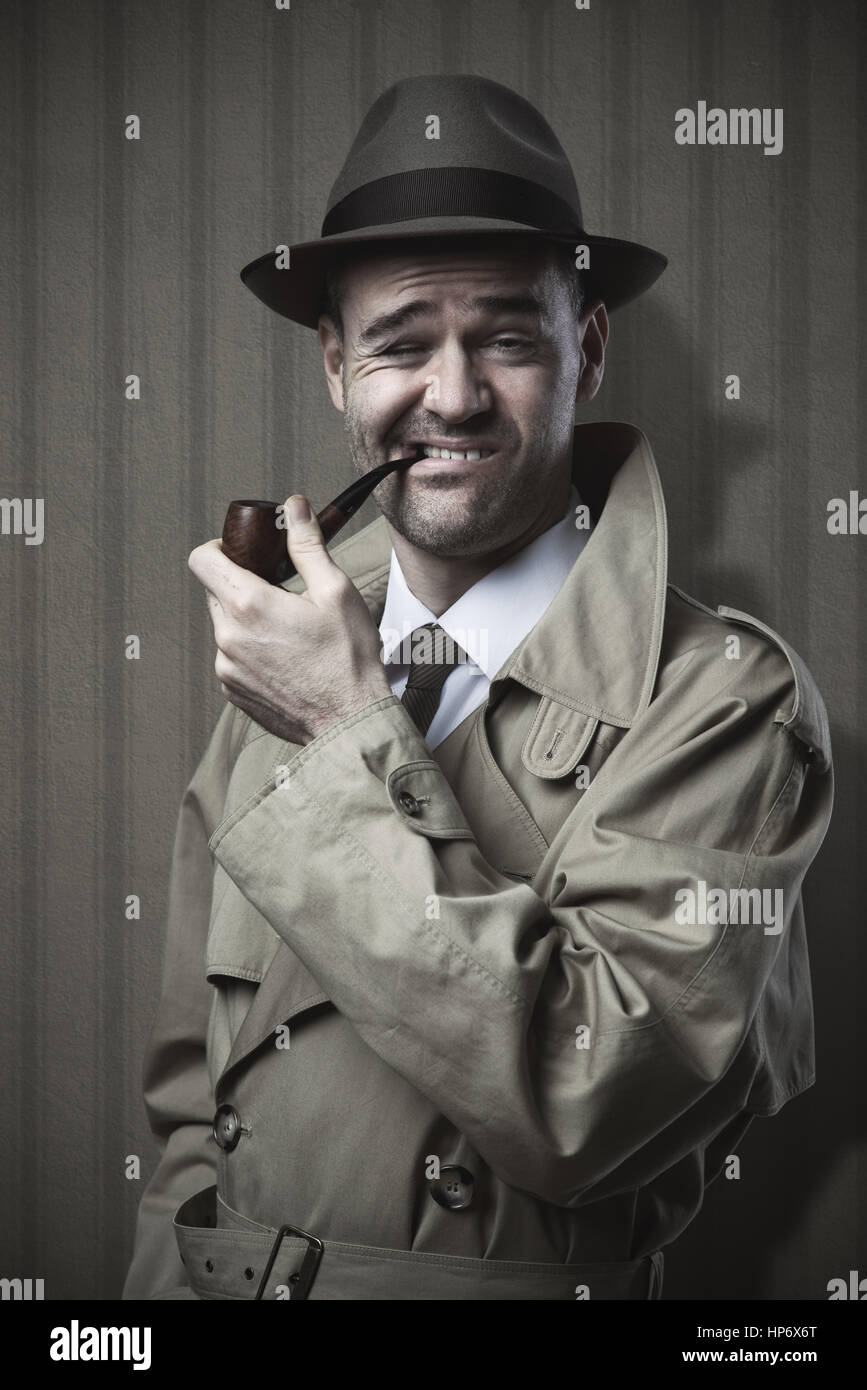 Funny detective smoking a pipe and making a weird face Stock Photo Alamy