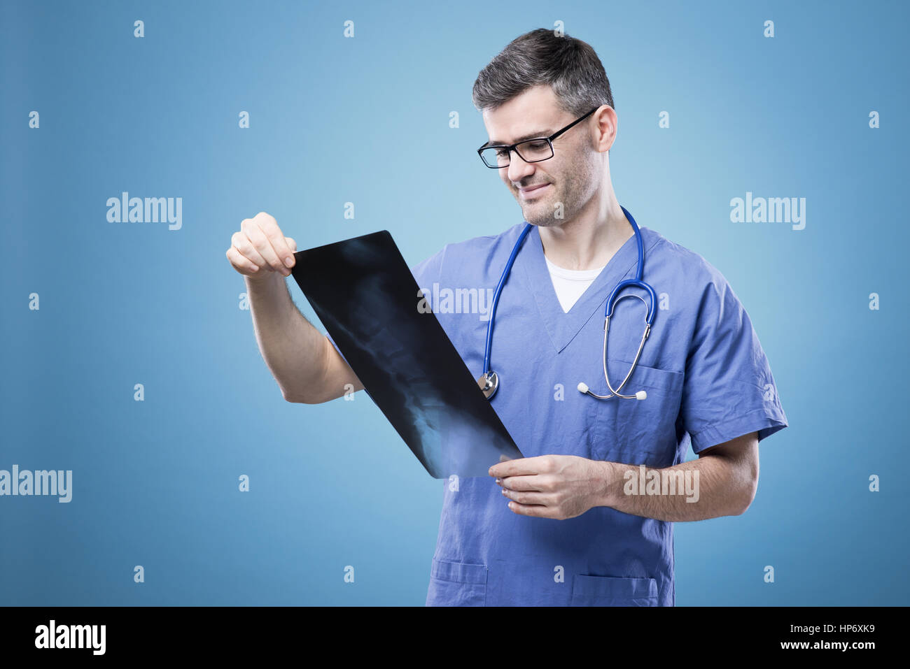 Confident radiologist examining an xray image during a medical exam