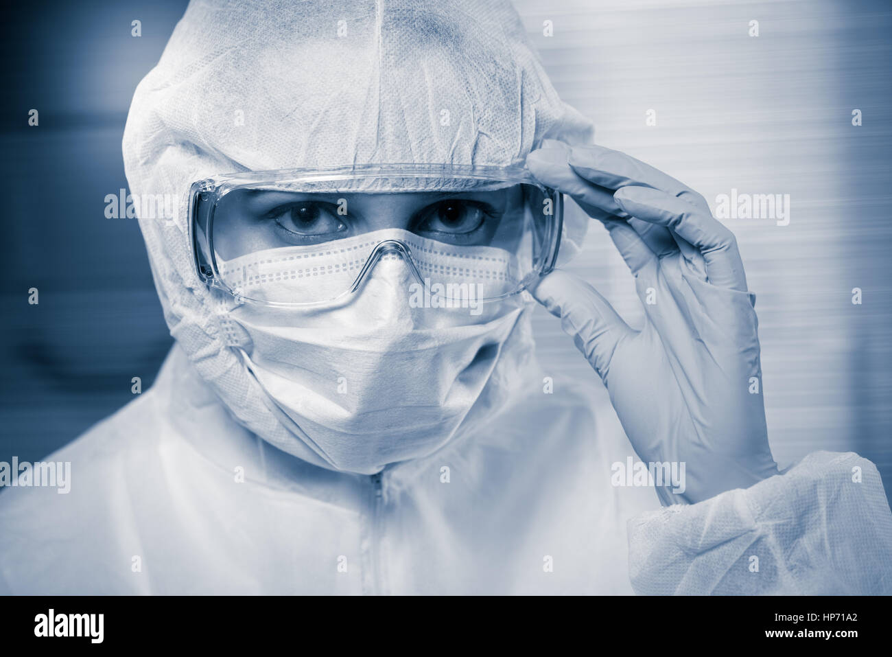 Researcher wearing hazmat protective suit and safety goggles Stock ...