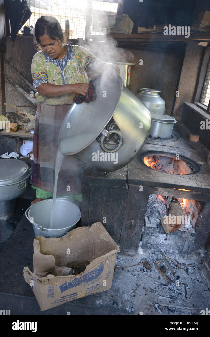 Mumbai, India - October 28, 2015 - Woman cooking rice in a traditional ...