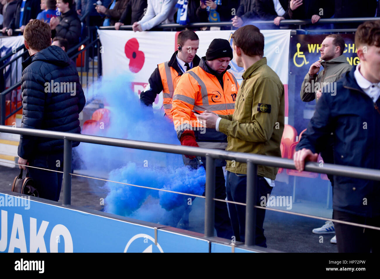Stewards remove a blue flare thrown after Portsmaouth had scored during the Sky Bet League 2 match between Barnet and Portsmouth at The Hive Stadium in London. February 18, 2017. Editorial use only. No merchandising. For Football images FA and Premier League restrictions apply inc. no internet/mobile usage without FAPL license - for details contact Football Dataco Stock Photo
